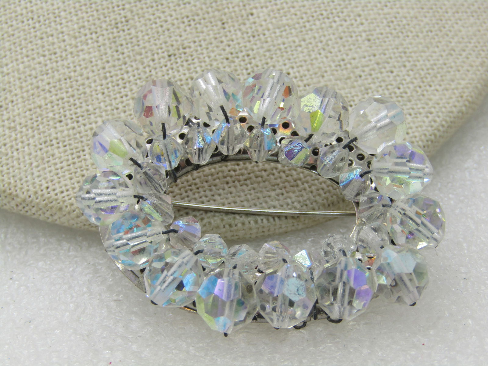 Vintage Aurora Borealis Crystal Beaded Brooch, Oval, 2": Vintage Aurora Borealis Crystal Beaded Brooch, Oval, 2" by 1.5", Open oval with faceted crystal beads , smaller in the center and larger on top. Mounted on silver tone frame. 1960's. Very good