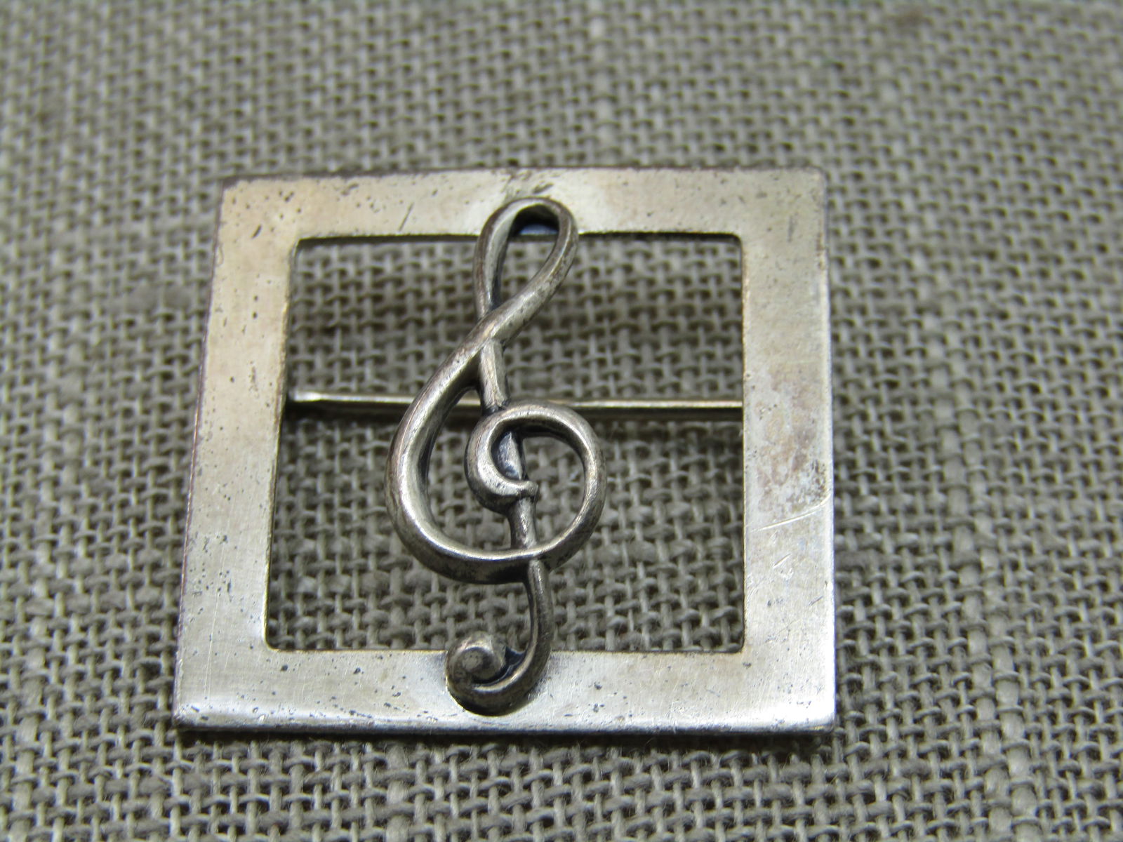 Vintage Beau Sterling Treble Clef Brooch, 1" Square Frame: Vintage Beau Sterling Treble Clef Brooch, 1" Square Frame, 1960's, weight is appx. 3.35 gr. It is signed Beau Sterling and tested. The treble clef is set on top of the frame with an open area inside t