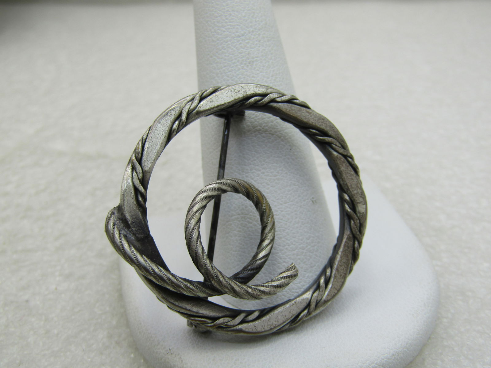 Vintage Burnished Sterling Circle Brooch, Coiled Accent 1.5" NL: Vintage Burnished Sterling Circle Brooch, Coiled Accent 1.5" , Appx. 12.87 grams. Rope accent intertwined with satin finished circle. Age is 1960's-1970's. Good to very good condition. Not marked/sign