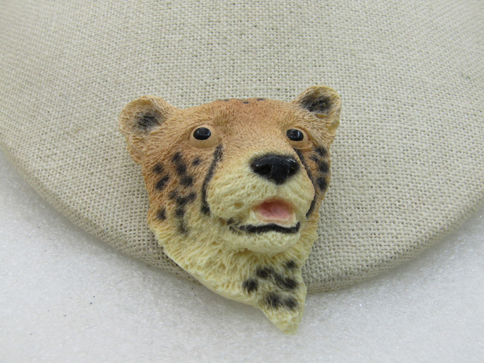 Vintage Big Cat Brooch, Painted Tan/Black/Cream, 2": Vintage Big Cat Brooch, Painted Tan/Black/Cream, 2" tall and wide. The colors of a tiger but more of a leopard look with black spotted markings, nose and from the eyes to them outh and a pale honey br