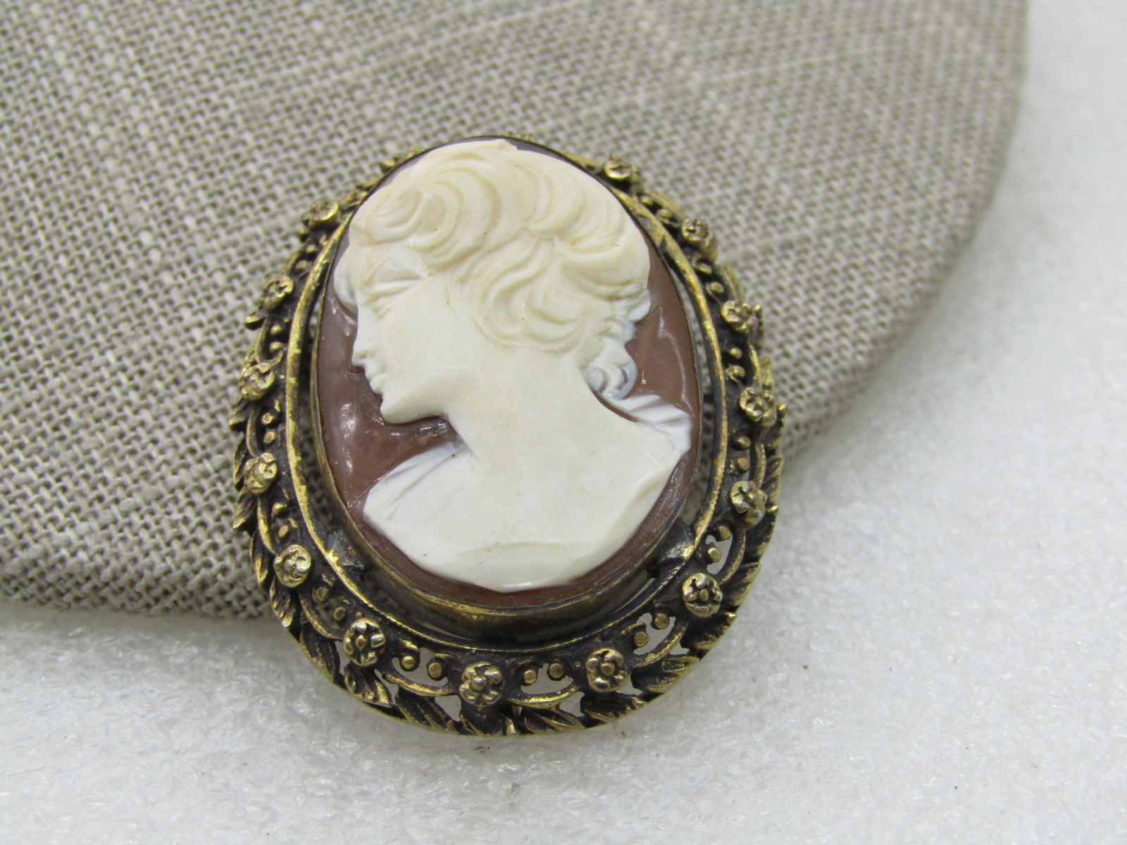 Vintage .800 Silver Cameo Pendant/Brooch, Gold over, Rose Frame, 1-7/8": Vintage .800 Silver Cameo Pendant/Brooch, Gold over, Rose Frame, 1-7/8" long with bail and 1.25" wide. Bezel-set came with a light to medium brown base and a white cameo. The images is wearing no jewe