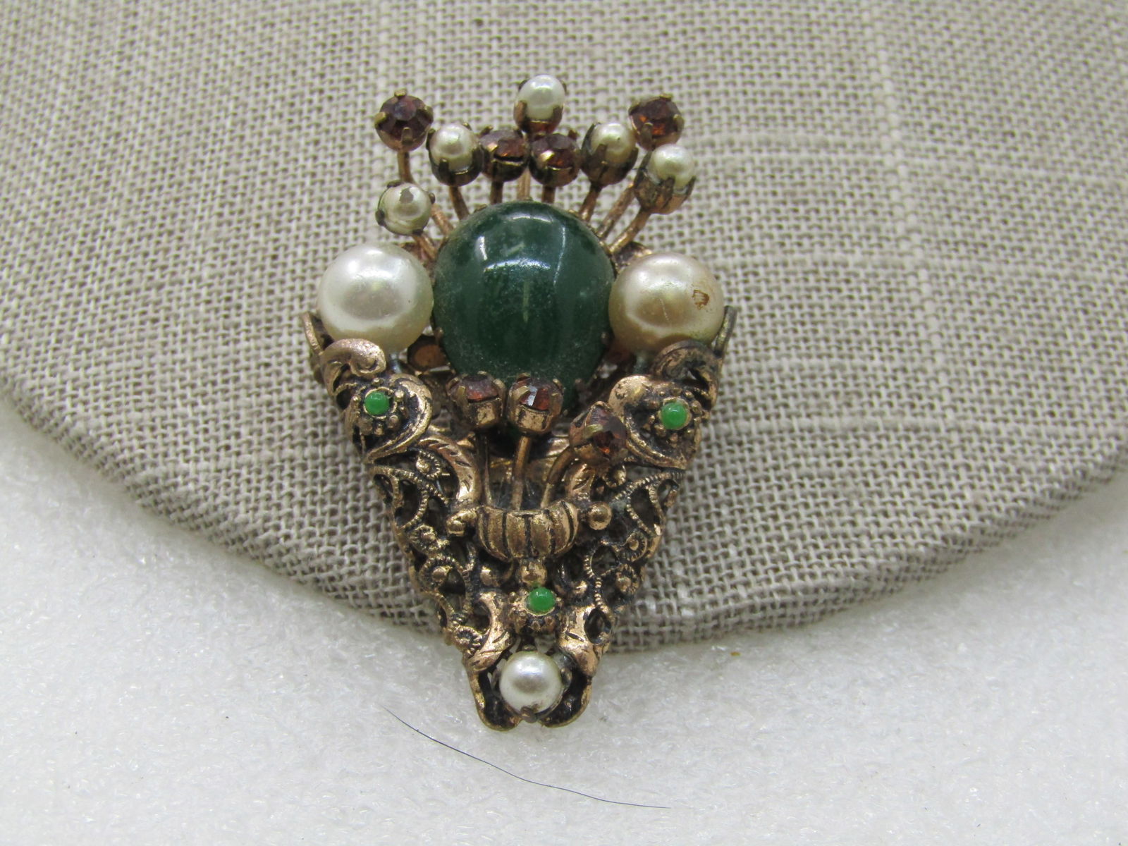 Vintage Austrian Crystal & Faux Pearl Brooch, 1920's-1930's: Vintage Austrian Crystal & Faux Pearl Brooch, 1920's-1930's, Lace-like pionted design with amethyst and green colored crystals and glass and faux pearls. The brooch is signed Austria, gold tone and ap