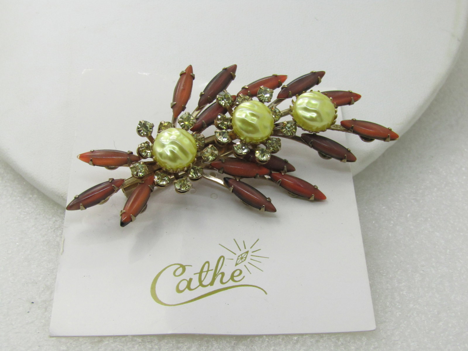 Vintage Cathe Signed Rhinestone Brooch, On Original Card, 3.25": Vintage Cathe Signed Rhinestone Brooch, On Original Card, 3.25" by 1.25". Elongated amberish glass elongated marquise cabchons with faux pearl ridged yellow pearl-like cabochons with a prong bezel aro