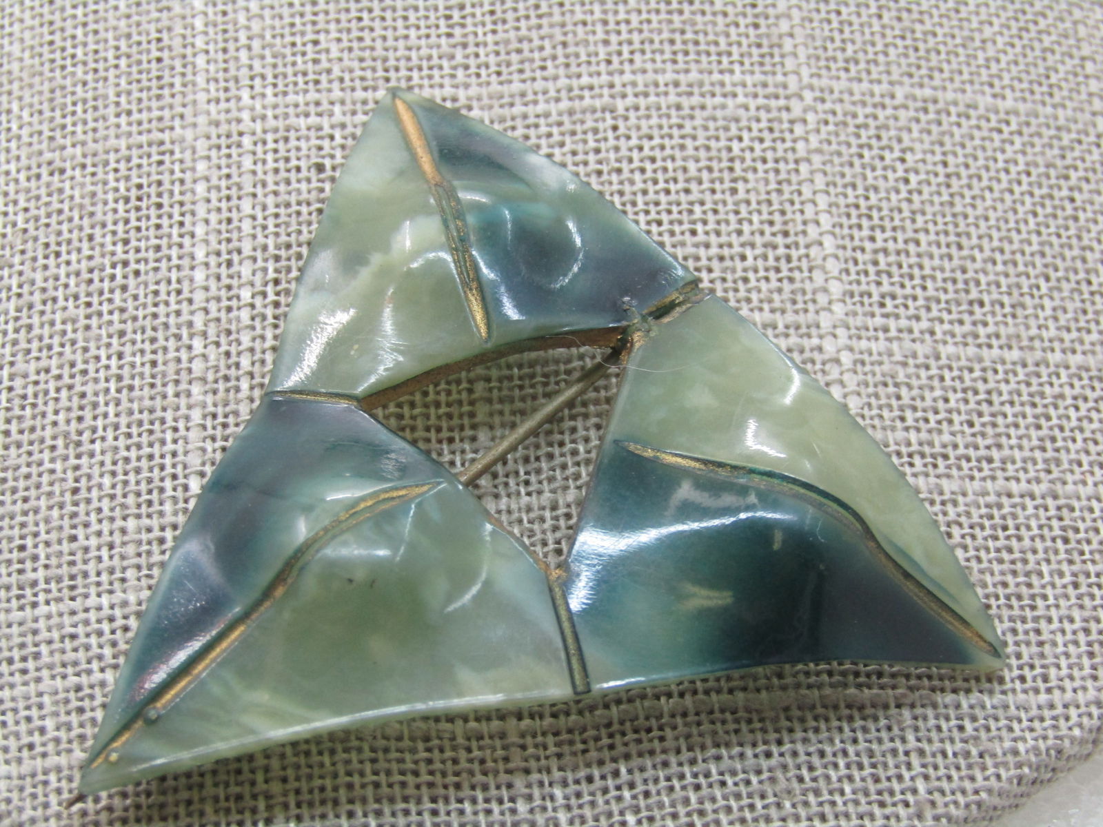Victorian Green Celluloid Brooch, Triangular, 2.25", C-Clasp: Victorian Green Celluloid Brooch, Triangular, 2.25" down each side with an open triangle in the center, carved gold accents down the center of each triangle which is two shades of green. The pin has