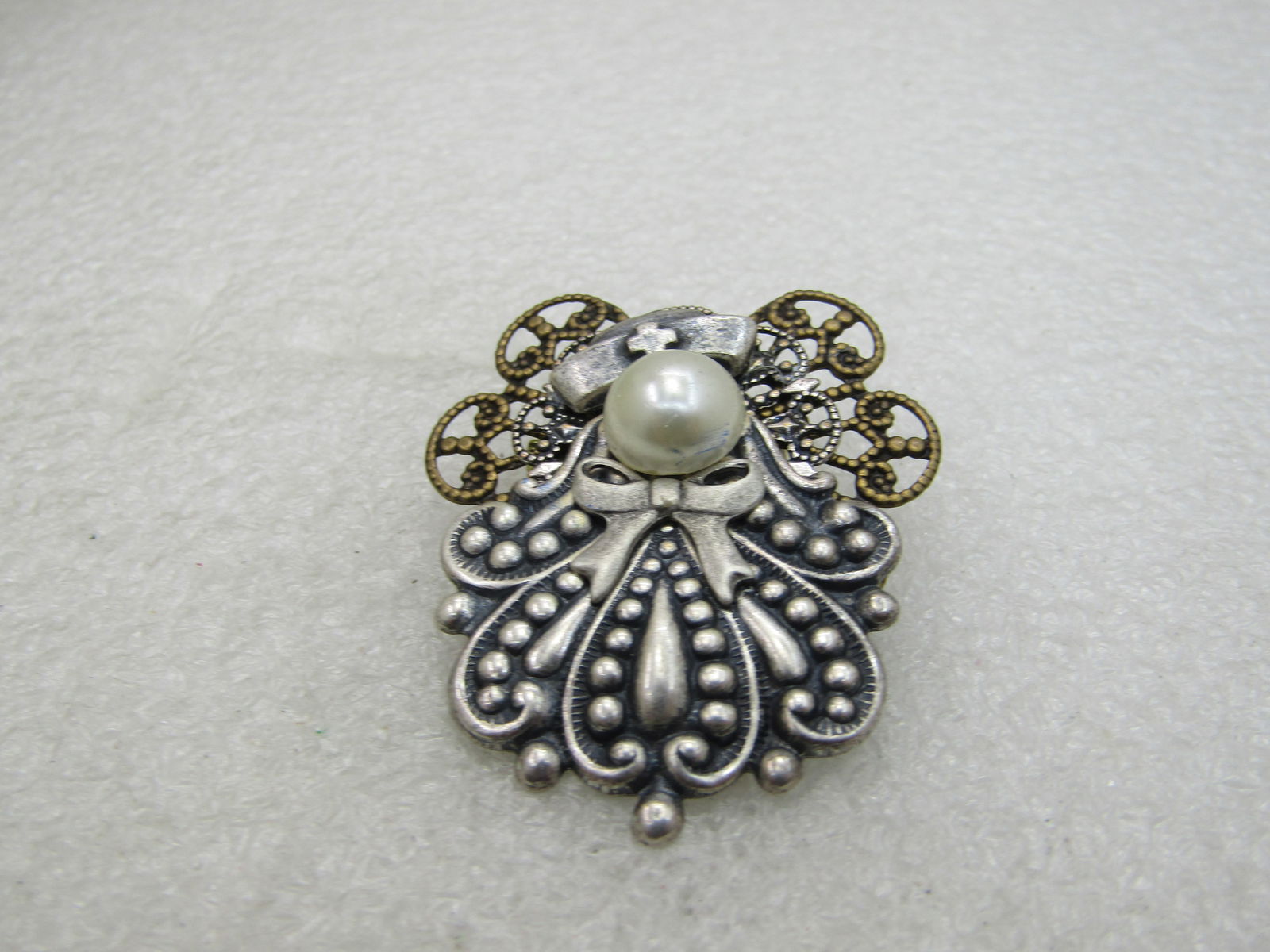 Two-Tone Angel Nurse Brooch, with Faux Pearl, 1.75": Two-Tone Angel Nurse Brooch, with Faux Pearl, 1.75", 1980's-1990's. This has silver flowing angel with wings and a nurse's cap and brassy gold tone larger wings behind. Not signed by the maker. Very g