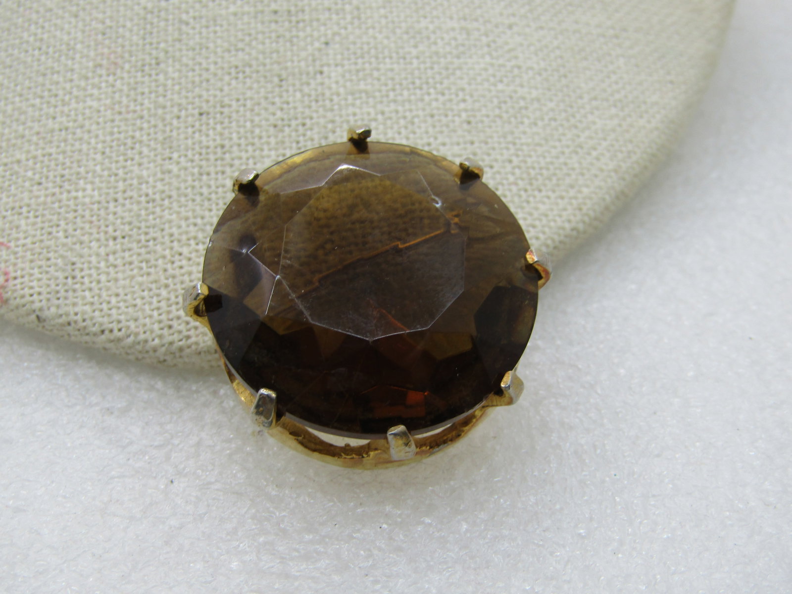 Vintage Smokey Glass Stone Brooch, 1.25" Prong-Set, 1960's: Vintage Smokey Glass Stone Brooch, 1.25" Prong-Set, 1960's, Gold Tone. 8 prong hold this smoky brown faceted glass stone. Appx. 17mm tall. Looks somewhat like a crown fromt he side. Very good