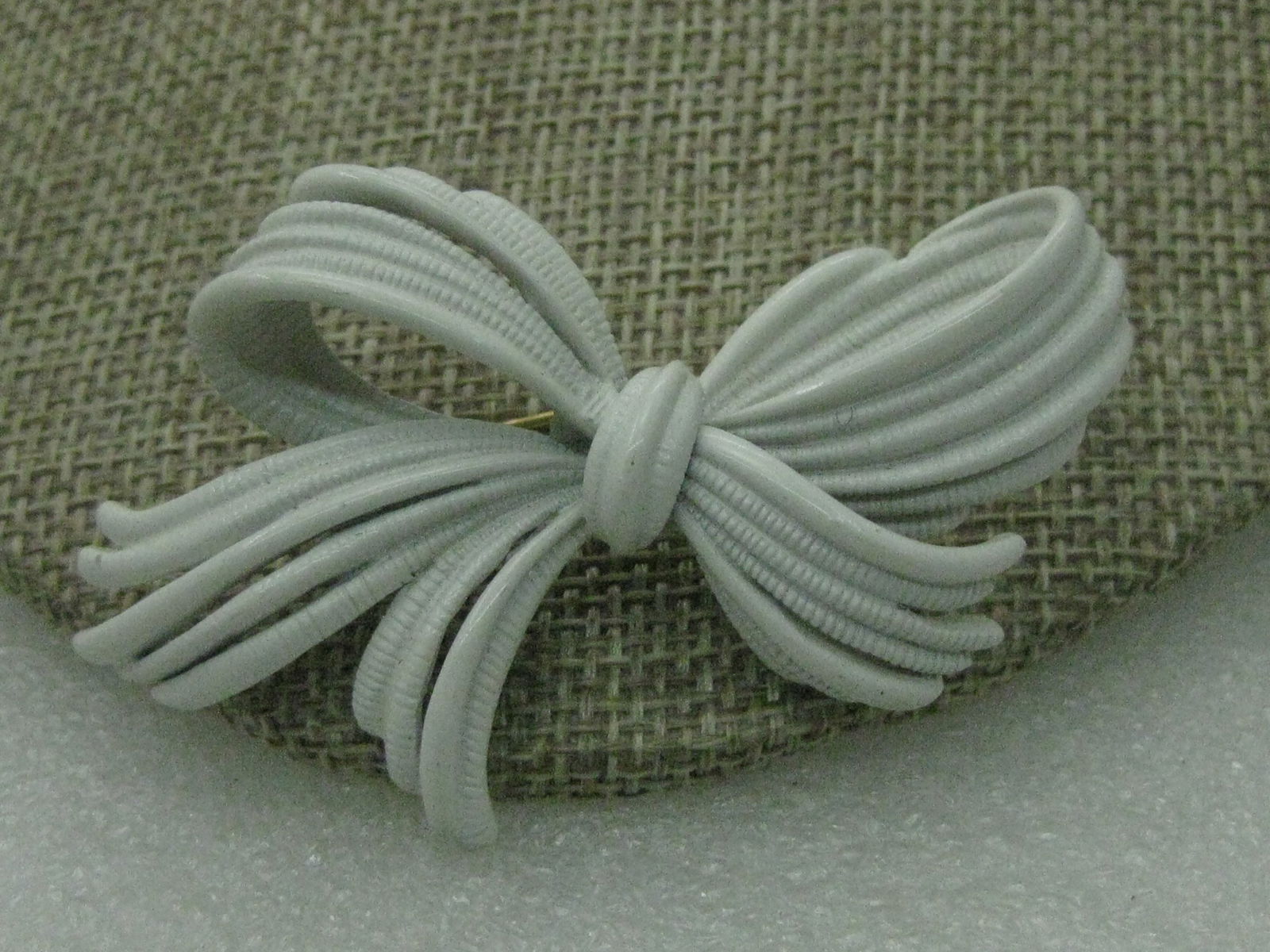 Vintage Monet White Bow Brooch 2", 1960's-1970's: Vintage Monet White Bow Brooch 2" wide 1.5" tall, Great for Christmas too, five looped strands create the bow. Signed monet on gold tag on back, gold tone pin back that is building into the brooch. 19