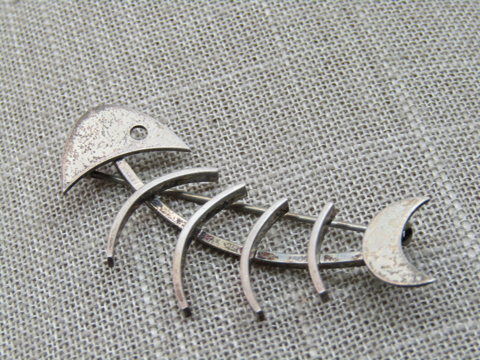 Vintage Beau Sterling Fish Skeleton Brooch, 1960's, 2.25": Vintage Beau Sterling Fish Skeleton Brooch, 2.25" and 7/8" wide. 1960's. Weight is appx. 5.45 gr. Signed Beau and marked sterling and tested. Curved design with mod design - head has a cut-out eye and