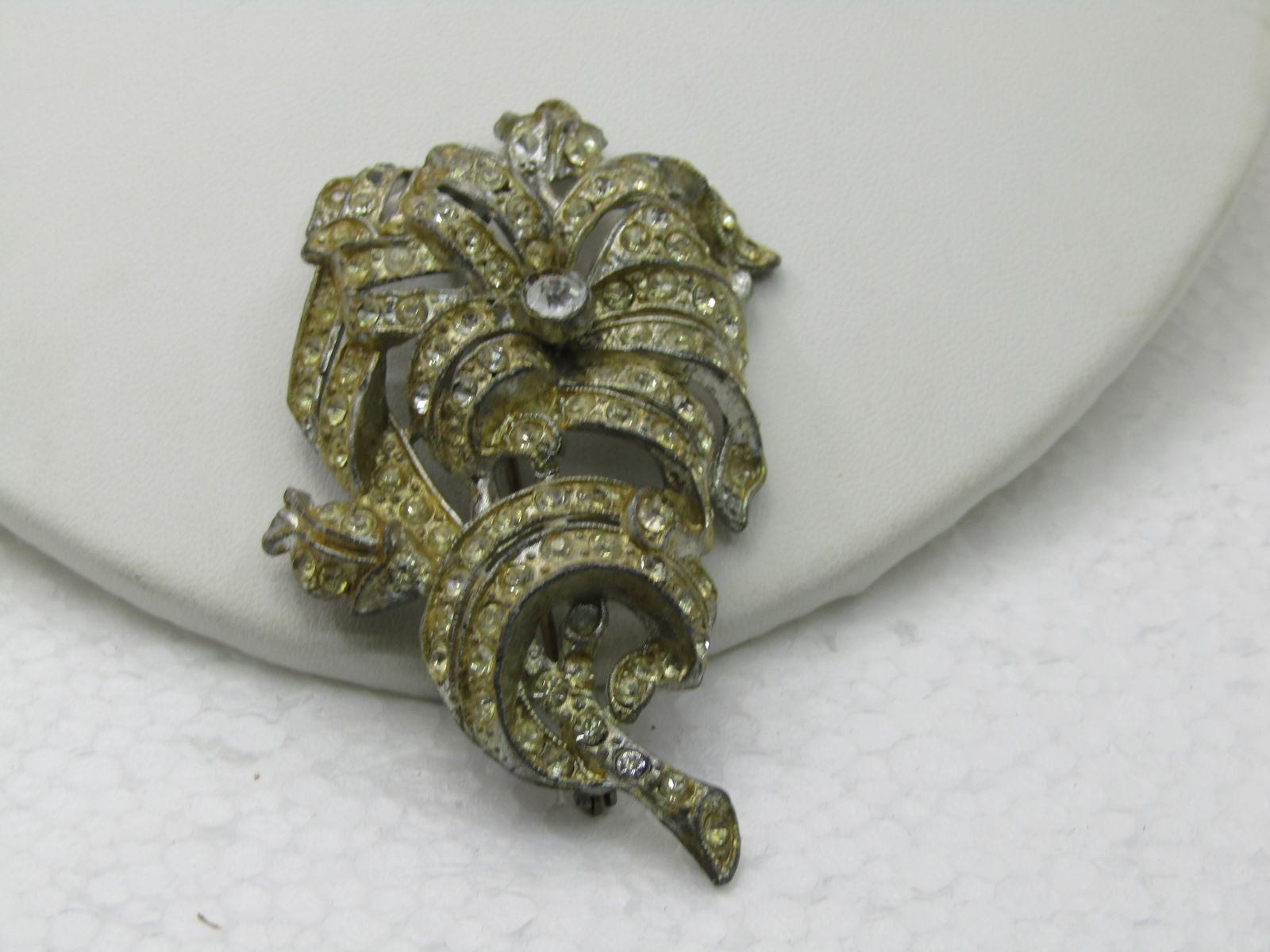 Vintage 1930's Art Deco Rhinestone Brooch, Pot Metal, 3": Vintage 1930's Art Deco Rhinestone Brooch, Pot Metal, 3" by 1.75". Layered bands of pave rhinestoines make up this brooch. Very elaborate for it's time. One stone looks cloudy - it is not - it was a r