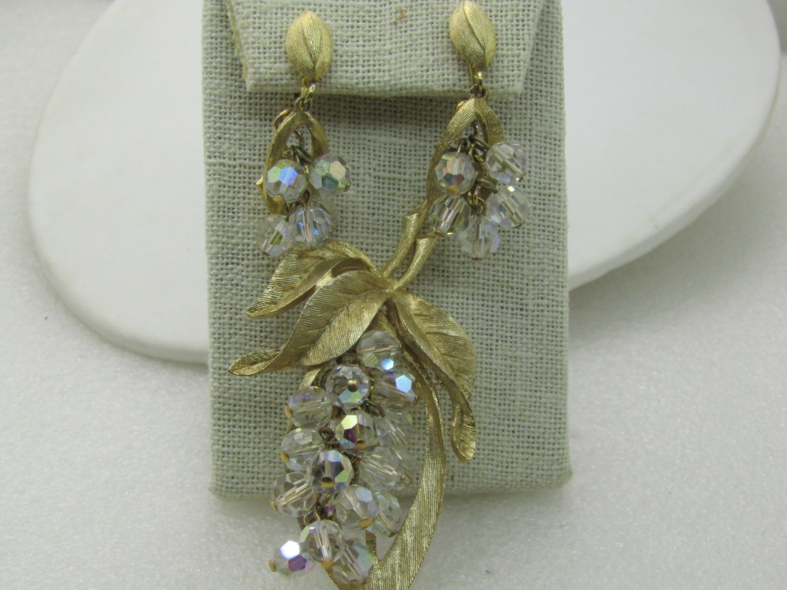 Vintage LJM Crystal Brooch & Earrings Set, 1960's. Laurentian Jewelry Mfg, Montreal: Vintage LJM Crystal Brooch & Earrings Set,1950's- 1960's. Laurentian Jewelry Mfg, Montreal. Rushed gold tone open grame with leaves and dangle aurora borealis crystal faceted beads, hanging in a chain