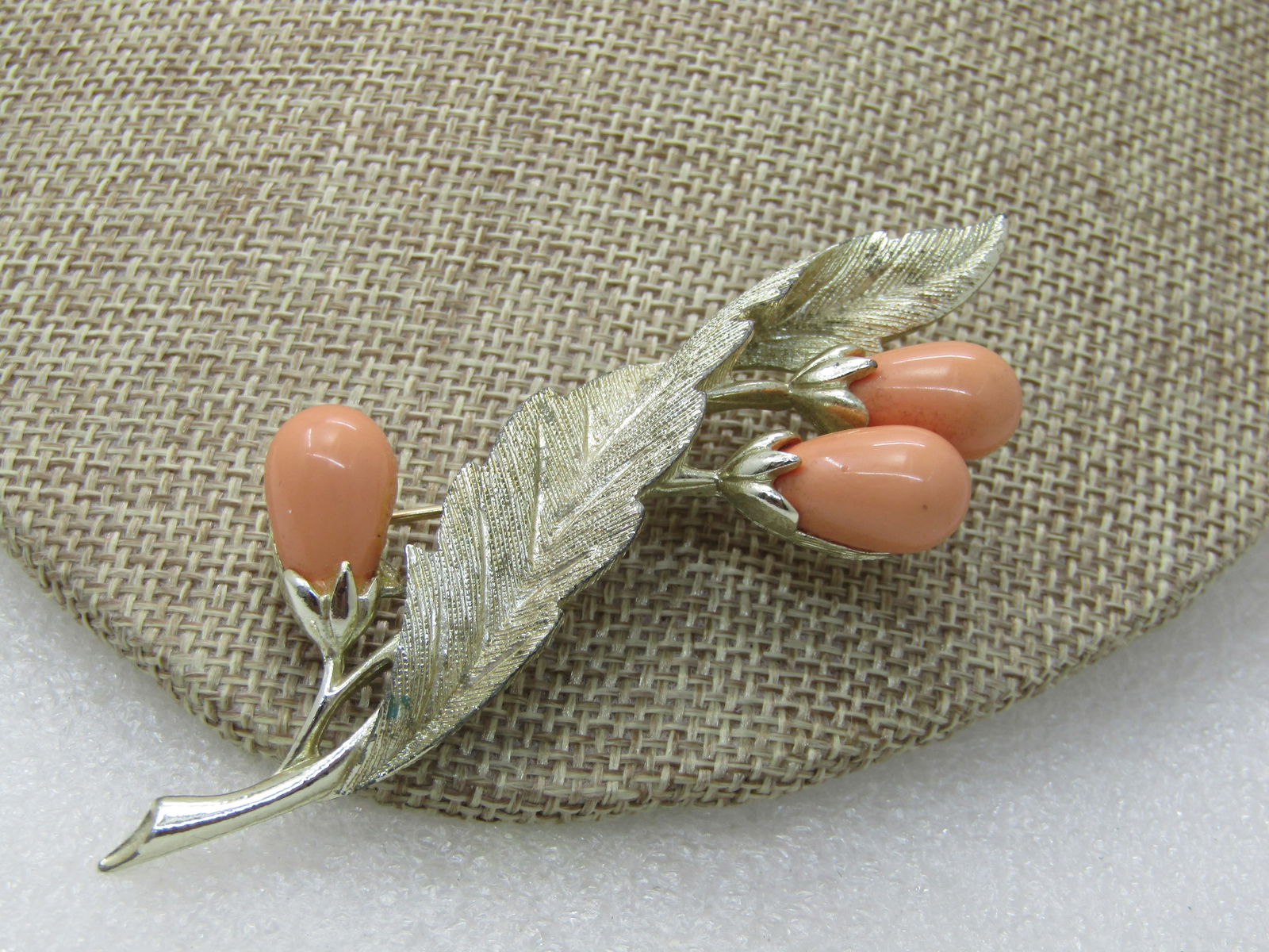 Vintage Leaf With Orange Berries Brooch, Sarah Coventry, 1960's-1970's: Vintage Leaf With Orange Berries Brooch, Sarah Coventry, 1960's-1970's, 3.5" tall and 1.25" wide. Three pale orange pods or berries on the textured leaf, that curls in the design, also smooth and shin