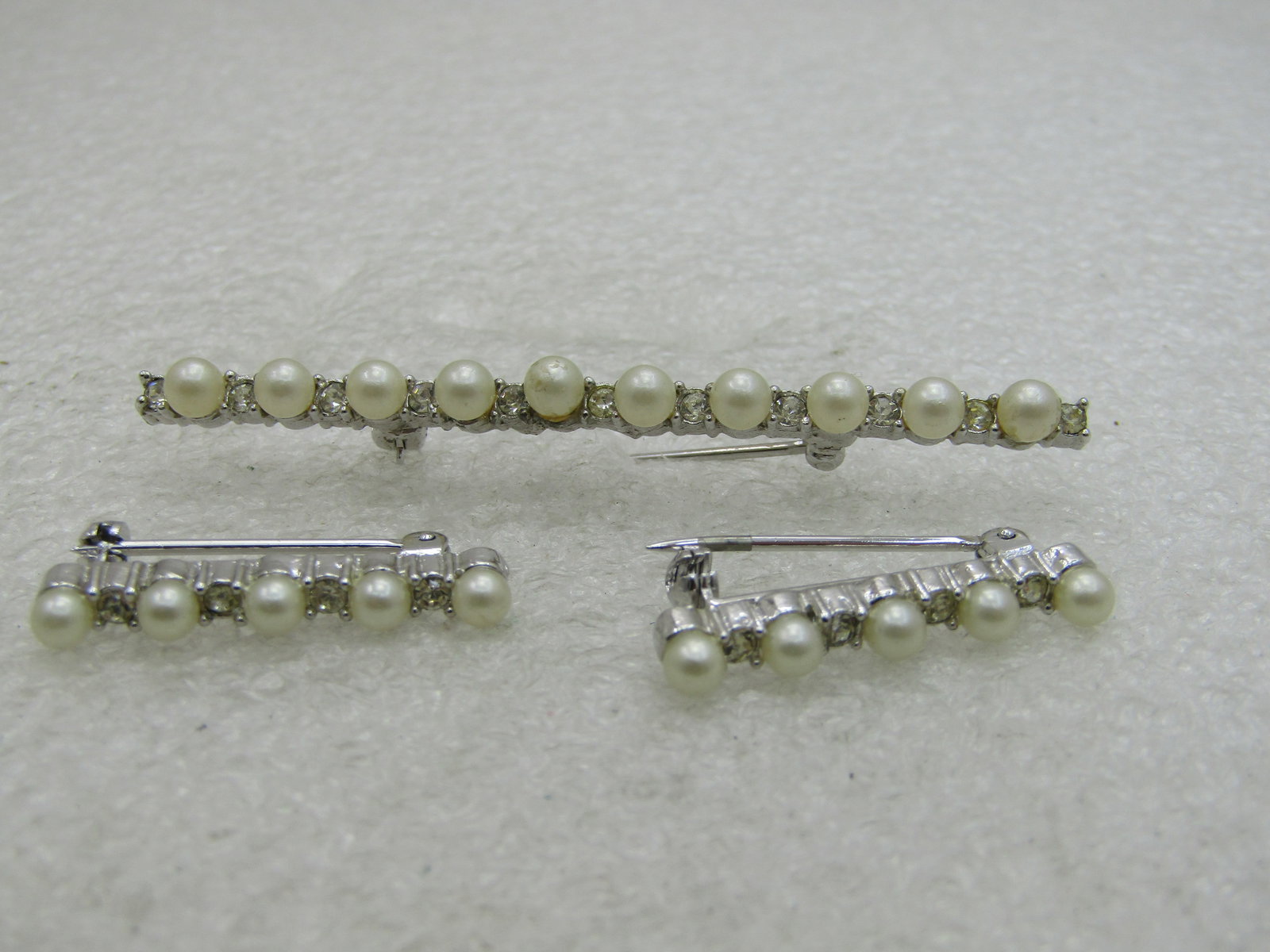Vintage Faux Pearl Scatter Brooch Set, signed Marvella, 1960's: Vintage Faux Pearl Scatter Brooch Set, signed Marvella, 1960's, silver tone bar brooch, the main one is 2.5" and the smaller two are slightly over 1" long. Width is slightly over 2mm. There is a clear