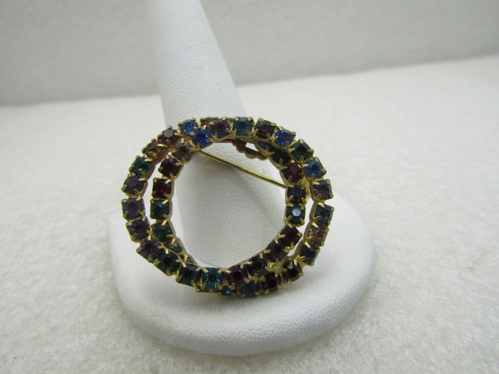 Vintage Double Circle Rhinestone Brooch, 1-3/8", 1960's-1970's: Vintage Double Circle Rhinestone Brooch, 1-3/8", 1960's-1970's, gold tone with green, green, blue, and golden appx. 3mm rhinestones, round and set in square setting. Typical wear for the vintage but