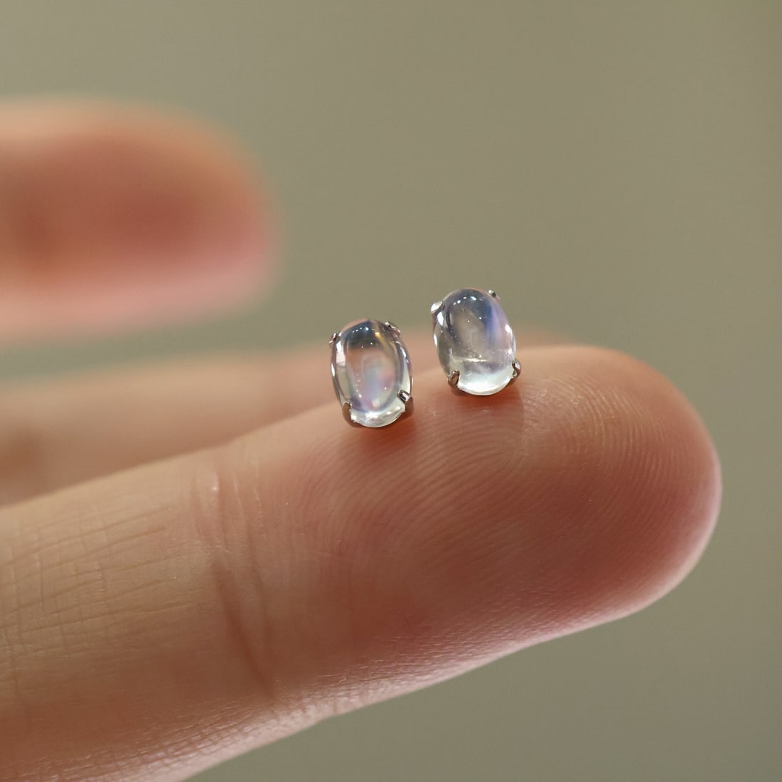 18K Gold Moonstone Stud Earrings: Title: 18K Gold Moonstone Stud Earrings Description: Pair of 18K gold stud earrings featuring natural moonstones, known as the "stone of lovers." The moonstones exhibit a soft, luminous glow