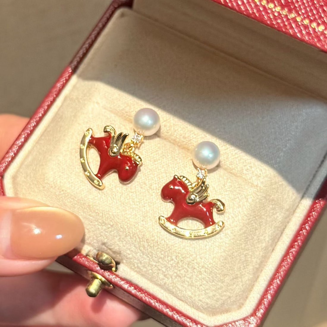 Redwood Horse Stud Earrings with 6-7mm Freshwater Pearls, 14K Gold Red Enamel Accents: Title: Redwood Horse Stud Earrings with 6-7mm Freshwater Pearls, 14K Gold Red Enamel Accents Description: Elegant redwood horse-shaped stud earrings featuring 6-7mm natural freshwater pearls. The earr