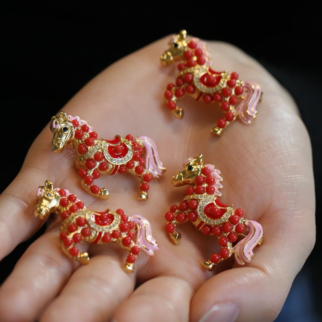Natural Red Coral Horse Brooch with Gilded and Pink Enamel Accents: Title: Natural Red Coral Horse Brooch with Gilded and Pink Enamel Accents Description: Elegant brooch featuring a horse motif crafted from natural red coral beads, accented with gilded and pink enamel