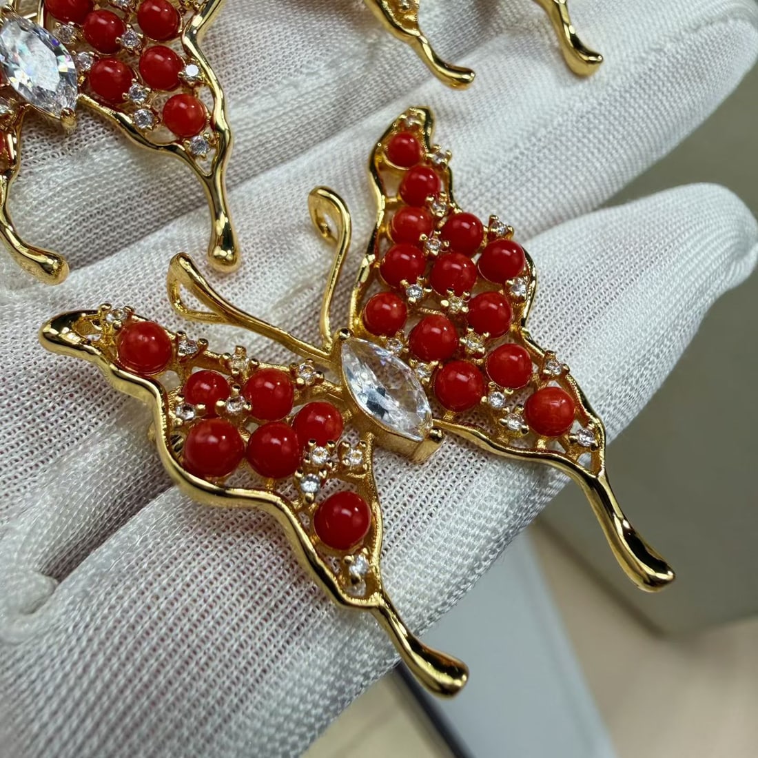Natural Red Coral Butterfly Brooch, Fashion Design: Title: Natural Red Coral Butterfly Brooch, Fashion Design Description: Elegant butterfly-shaped brooch crafted from natural red coral. The design combines refined craftsmanship with a playful, fashion