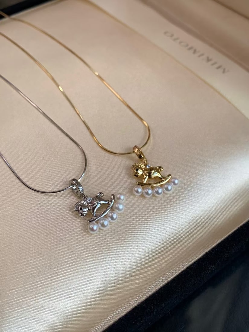 Silver Snake Chain Pony Necklace with 3-4mm Freshwater Pearls: Title: Silver Snake Chain Pony Necklace with 3-4mm Freshwater Pearls Description: Charming pony-shaped necklace featuring 3-4mm near-round, luminous freshwater pearls. Set on a sterling silver snake c
