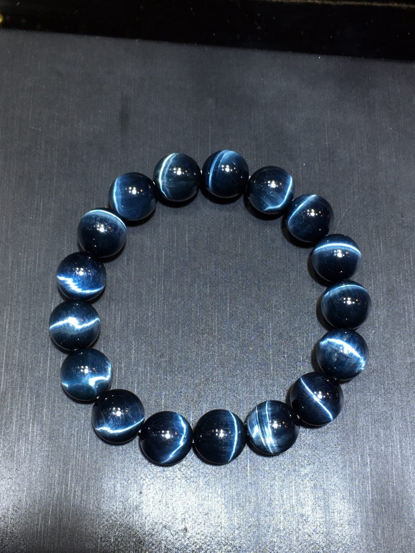 Natural 12mm Blue Tiger Eye Bracelet - Polished, Clear Stripes, Powerful Energy: Title: Natural 12mm Blue Tiger Eye Bracelet - Polished, Clear Stripes, Powerful Energy Description: Exquisite bracelet featuring 12mm natural blue tiger eye beads with polished luster and transparent