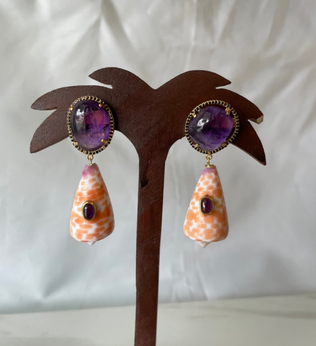 Tessalatus Shell Earrings with Amethyst Cabochons: Title:Tessalatus Shell Earrings with Amethyst Cabochons Description:Black Spinel-framed, Amethyst cabochons with drops of Conus Tessalatus shells set with oval, Amethyst cabochons. Pierced Vermeil ear