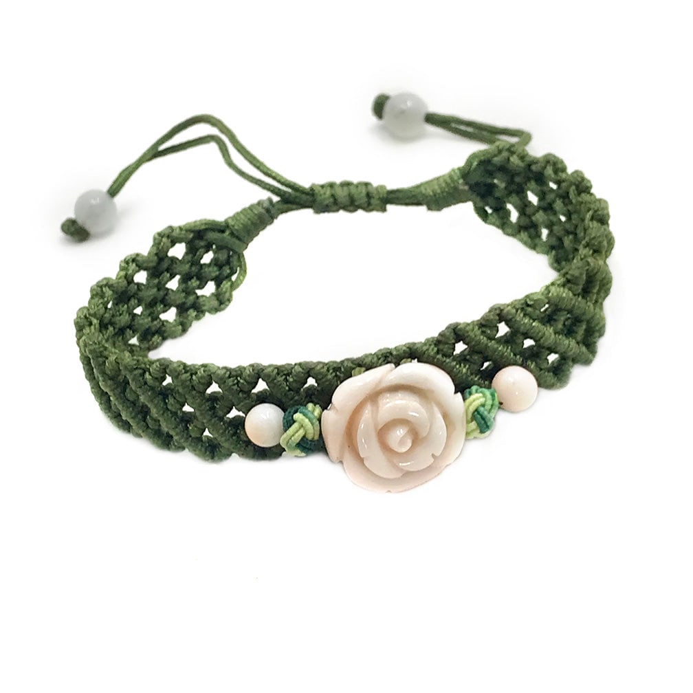 Carved Angel Skin Coral Bracelet: This is a carved angel skin coral bracelet. It features a 15 x 18mm carved rose on hand knotted silk band. The bracelet adjusts in size with a slipknot up to 10 inches. I bought it at a Jewelry Market