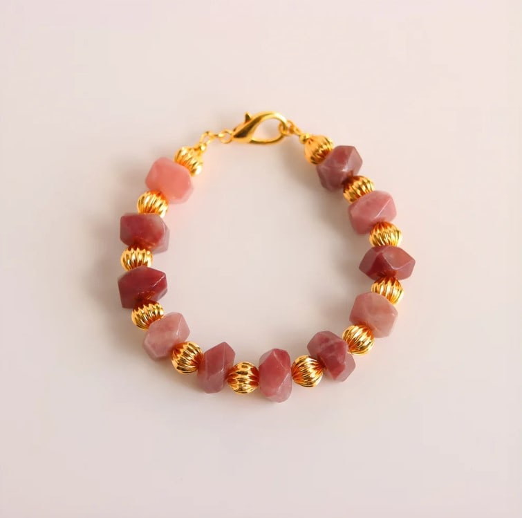 Pink Botswana Agate and Gold Beaded Bracelet: Title:Pink Botswana Agate and Gold Beaded BraceletDescription:This pink Botswana agate bracelet features the soft, natural beauty of mauve-toned stones paired with radiant 18k gold-plated brass. Each