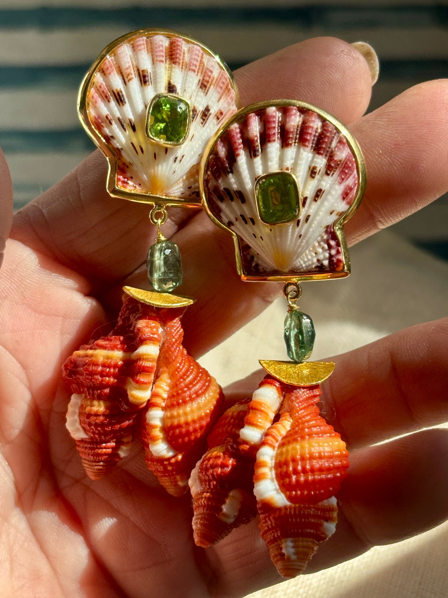Cymabatium Shell Earrings with Peridot: Title:Cymabatium Shell Earrings with Peridot Description:Pair of darling Cymabatium Shell Earrings with Calico Scallops, set with faceted Peridot, on top - Signed CSS - Vermeil - 2.5" Drop - Clip/Post