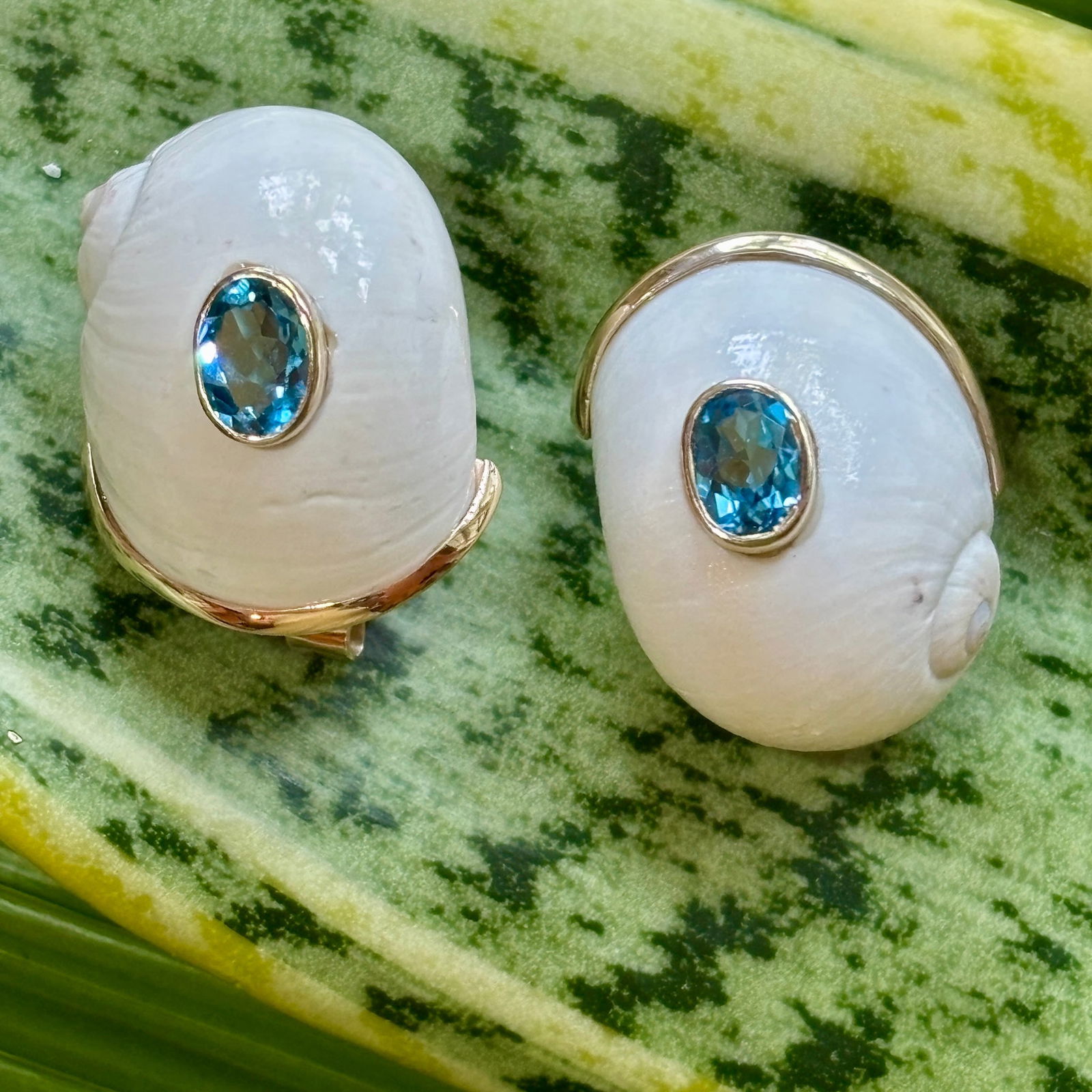 White Natica Shell "Sleeper" Earrings with Blue Topaz: Title:White Natica Shell "Sleeper" Earrings with Blue Topaz Description:Substantial pair of "Sleeper" Gold Earrings of pure white Natica Shells set with Blue Topaz - Signed CSS - 10-karat Gold - 1" Lo