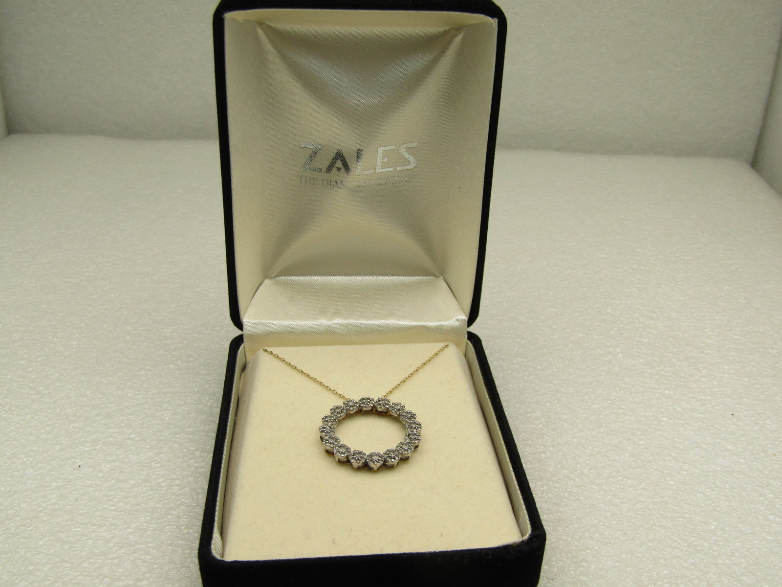 10kt Diamond Floral Blossom Circle Necklace, Singed JWBrR, Zales Jeweler's, 18": 10kt Diamond Floral Blossom Circle Necklace, Zale's Jeweler's, 18" comes in original box. White gold setting under the diamonds and the underside of the circle and chain and yellow gold. Weight is app
