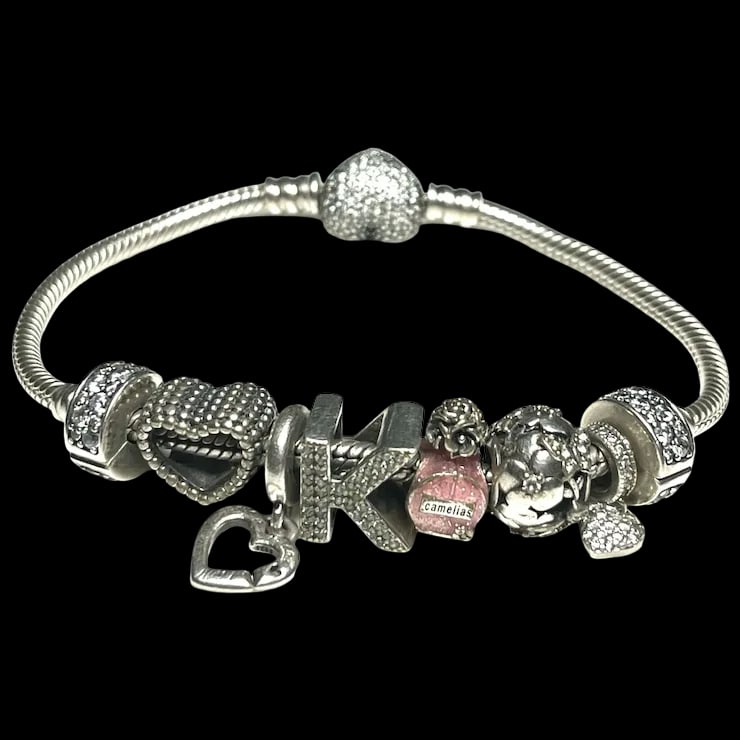 Estate Sterling Silver Pandora Charm Bracelet: Title: Estate Sterling Silver Pandora Charm Bracelet Description: Estate Sterling Silver Pandora Charm BraceletHallmarked: Pandora 925Weighs 30 grams Bracelet Measures Approx. 7.5 inches Reserve: $199