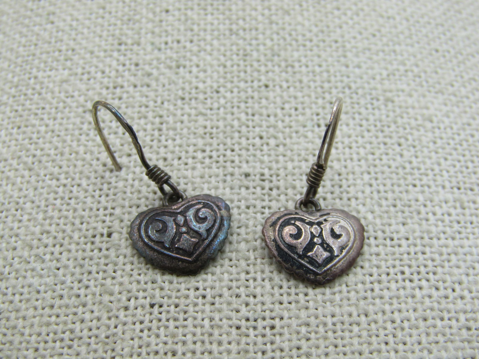 Vintage Sterling Silver Dangling Heart Earrings, Pierced, with design: Vintage Sterling Silver Dangling Heart Earrings, Pierced, with design. Appx. 3/4" tall from curve in hook post and 1/2" wide at the widest point of the heart. Weight is appx. 1.13 grams. They are mark