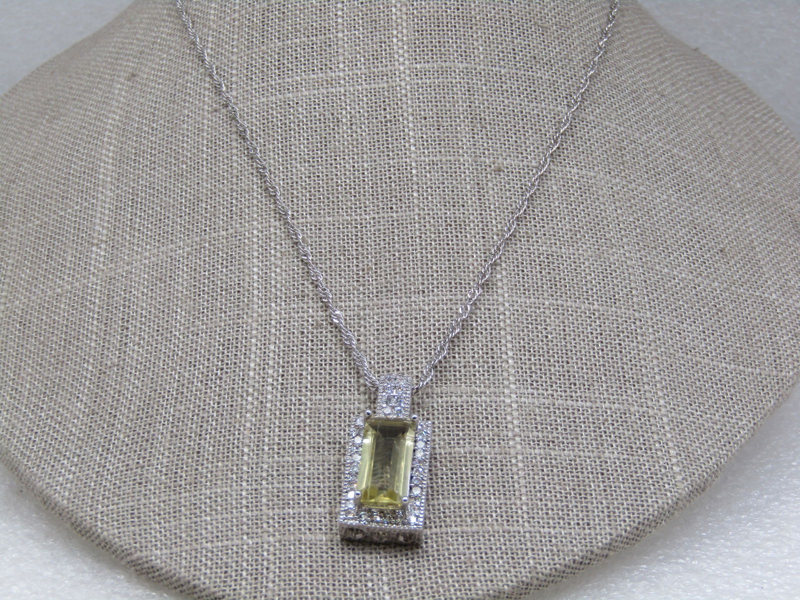 Costume Art Deco Yellow & Clear CZ Necklace, 21": Costume Art Deco Yellow & Clear CZ Necklace, 21". Silver tone Singapore link chain that is 18" long with a 3" extender chain, lobster clasp. Rectangular pave set clear CZ's around the raised rectangul