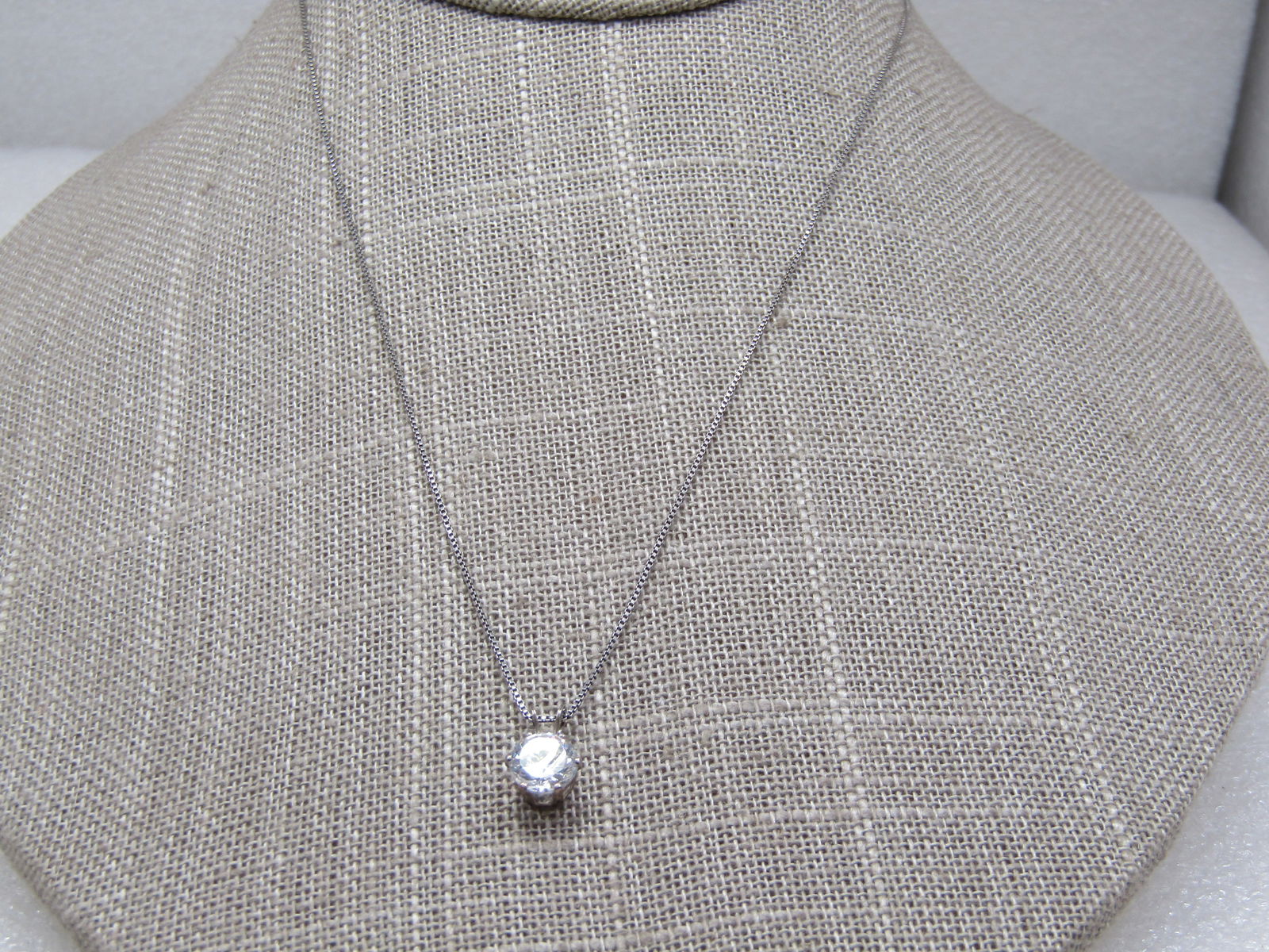 Vintage Sterling CZ Solitaire Necklace, 18" Sigined OTC: Vintage Sterling CZ Solitaire Necklace, 18" Sigined OTC. Marked .925 and tested. Weight is appx. 2.08 gr. The CZ is appx. 1ctw. Chain is a box chain, appx. .6mm. Age is appx. 1980's-1990's. Very good