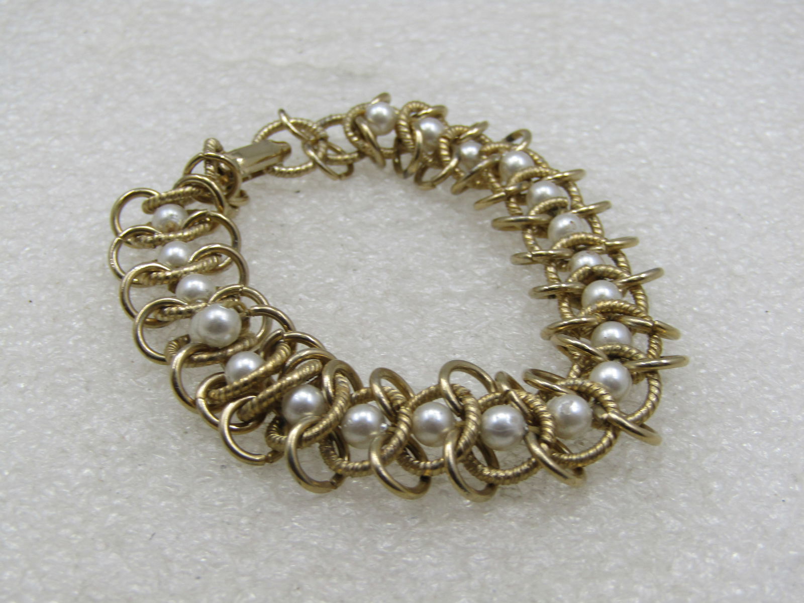 Vintage Faux Pearl Woven Link Bracelet, 6.75": Vintage Faux Pearl Woven Link Bracelet, 6.75". Appx. 13.5mm wide with a mix of smooth ahd shiny links on the sides and a center textured link down the middle with an appx. 4mm pearl inside every linke
