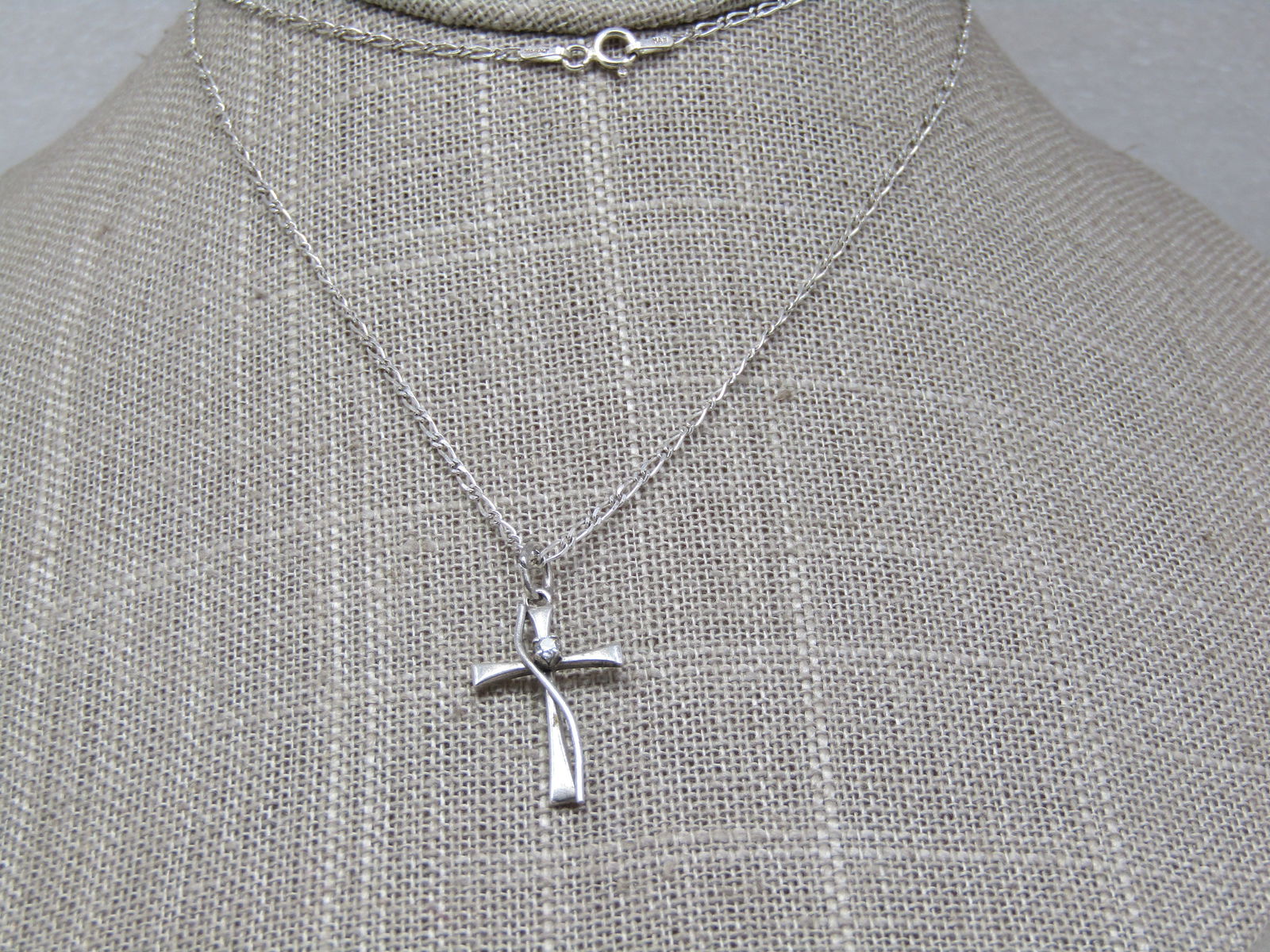 Vintage Sterling Cross Necklace with CZ, 24": Vintage Sterling Cross Necklace with CZ, 24", 1.3mm wide. Signed HAN. the cross is 1" long with a curved accent going down the length of the cross and a center 1.5mm clear CZ set raised at the