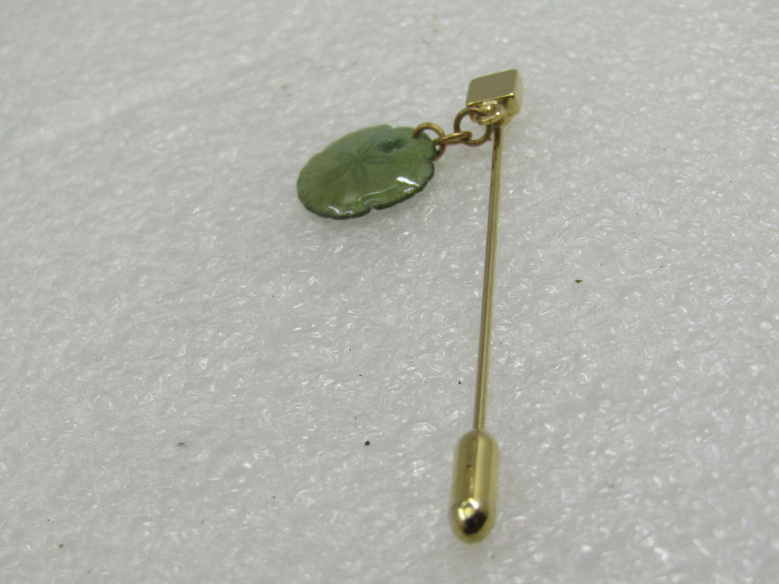Vintage Sand Dollar Stick Pin, New Old Stock: Vintage Sand Dollar Stick Pin, New Old Stock, on original card. Small 5/8" sand dollar lacquered, green sand dollar with a gold tone stick pin, square top from which the sand dollar hangs from on a 1/