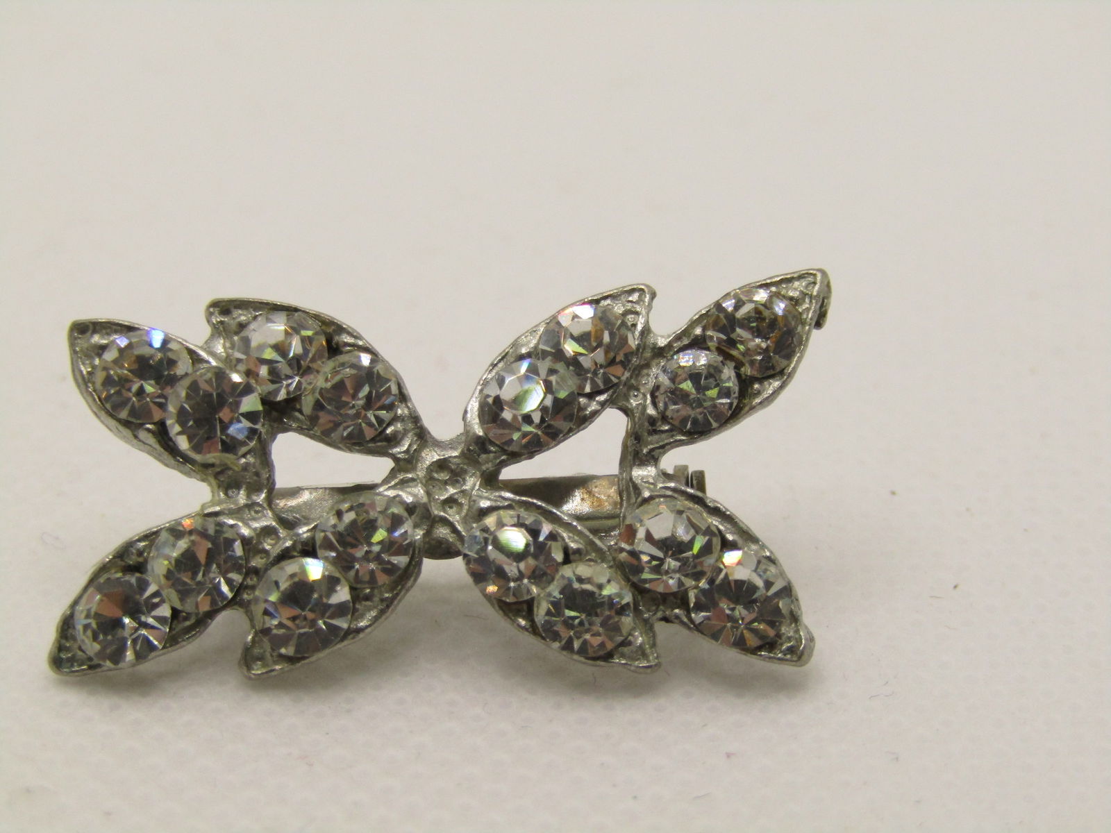 Vintage Art Deco Rhinestone Brooch, 1.25" Pointed Design: Vintage Art Deco Rhinestone Brooch, 1.25" wide and 3/4" tall. Pointed Design with two round rhienstones set in a pointed setting giving it the look of marquise stones. Not signed by the maker. Age is