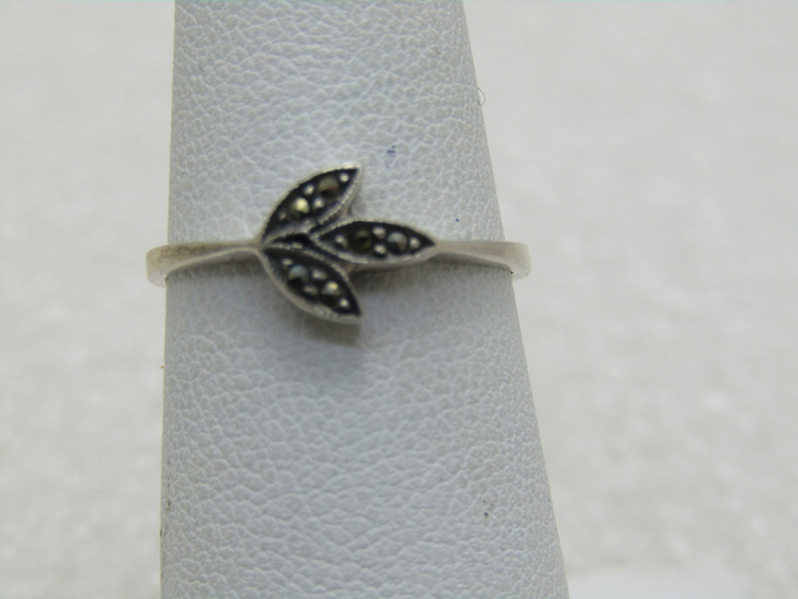 Vintage Sterling Silver Marcasite Leaf Ring, Sz. 6: Vintage Sterling Silver Marcasite Leaf Ring, Sz. 6, appx. 1.37 grams. Three little leaves, top is appx. 7.3mm by 7.5mm. The band is appx. 1.1mm on top and widens to appx. 2.2mm at the back of the fing