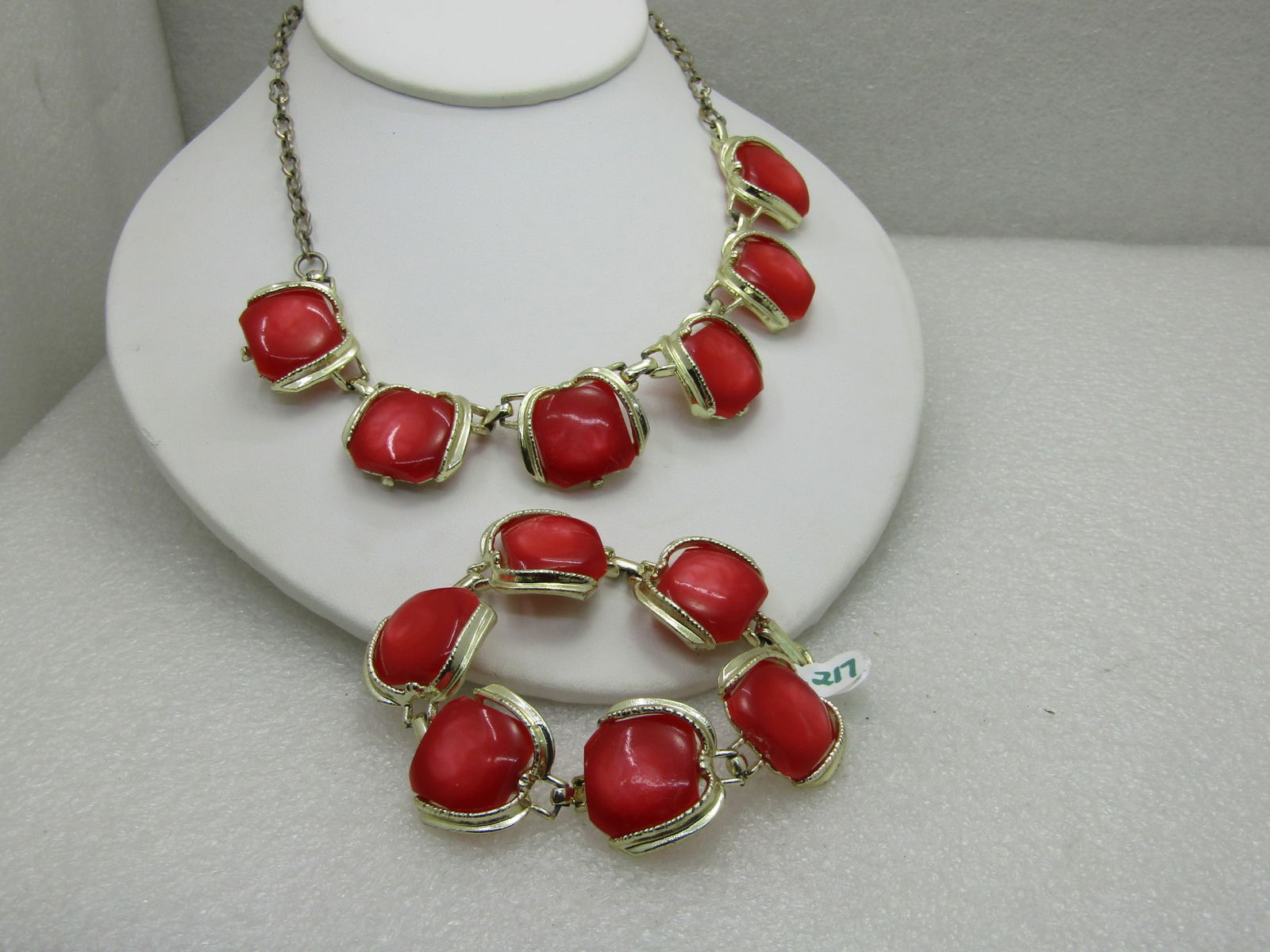 Vintage Orange Thermoset Necklace and Bracelet Set 1960's: Vintage 1960's Orange Thermoset Necklace & Bracelet Set. The necklace is 16" Long and appx. 1" wide, hook clasp. The bracelet is 7,75" long and 24.3mm wide. Gold tone setting with an open frame around