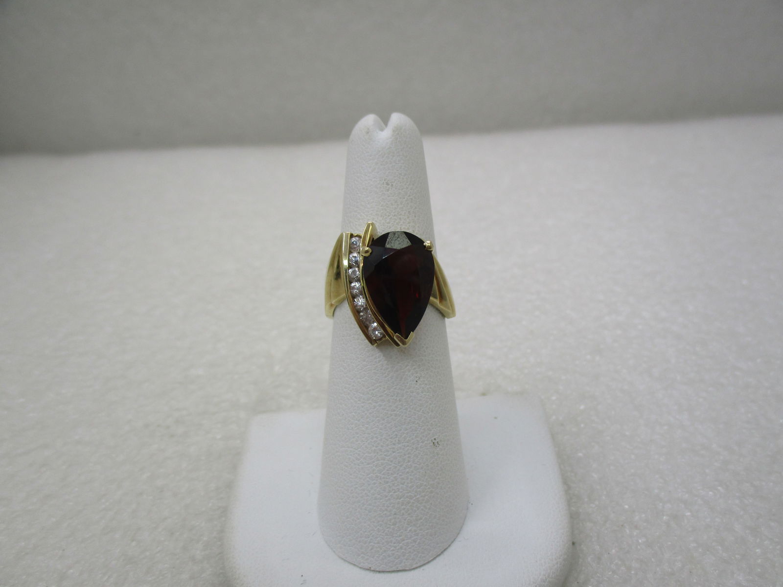 10KT Vintage Rubellite, White Topaz Ring, Mod Statement, Sz. 6.75: 10kt Gold Pear Rubellite, Clear Topaz Ring, Abstract/Modern/Statement, size 6.75. Weight is 5.60 grams. This ring is a bold and dynamic abstract and modern designed ring from the later 1900's. It is s