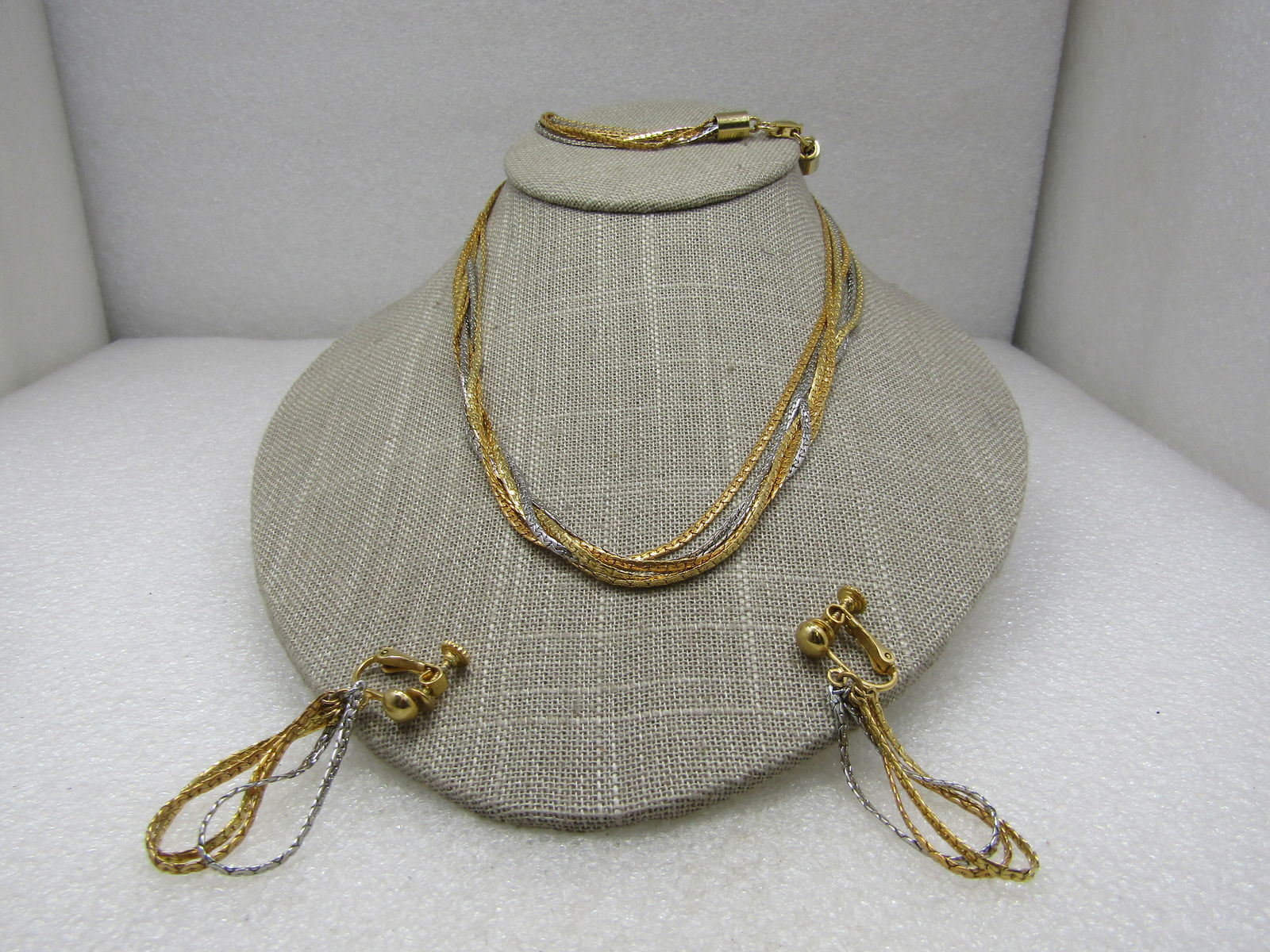 Vintage 7 Strand Two-Tone Necklace Earrings Set, Clip, 24": Vintage 7 Strand Two-Tone Necklace 24", Earrings Set, Hinged Screwback 2", " in silver tone and gold tone herrinbone link. each strand is appx. 2mm wide. Barrell end caps with a flip clasp. The earrin