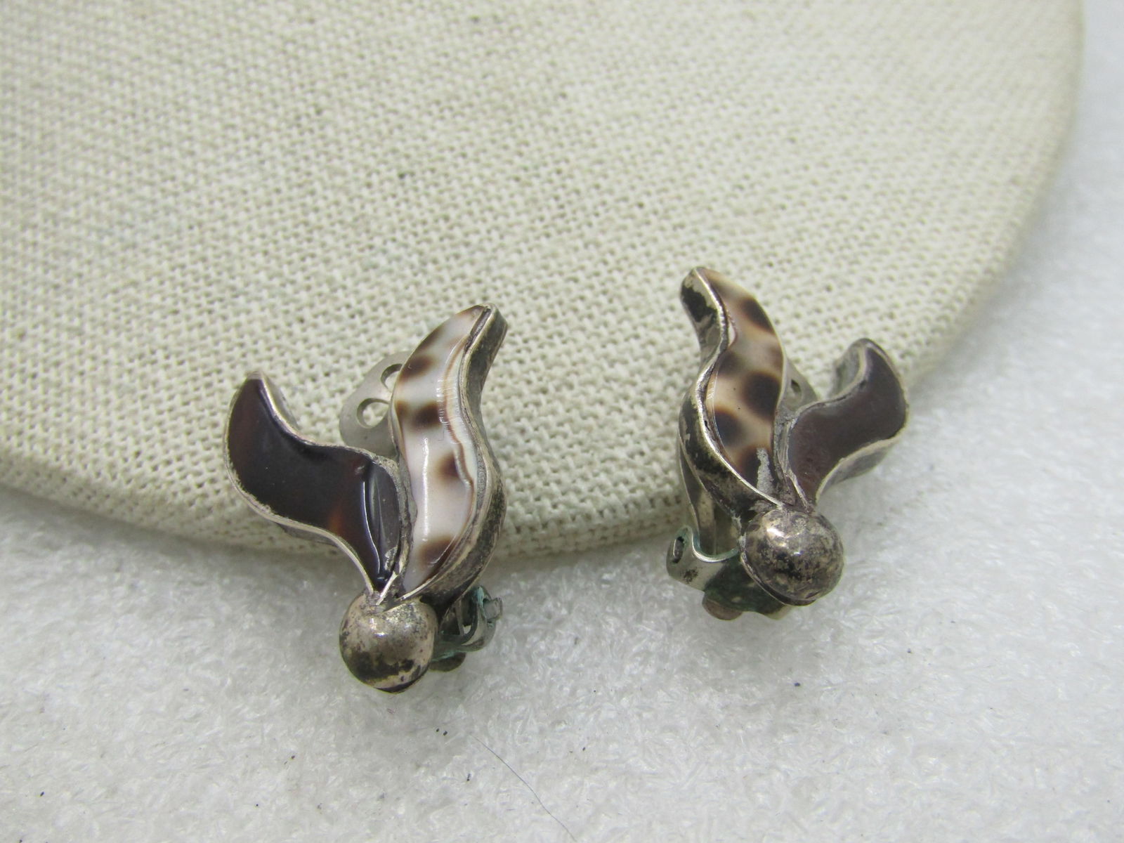 Vintage Sterling Southwestern Inlaid Horn Earrings, Clip 1950's-1960's: Vintage Sterling Southwestern Inlaid Horn Earrings, Clip 1950's-1960's, Brown horn and brown/tan spotted horn or shell. 1" by 5/8", 7.66 grams. Good condition with oxidation that can be cleaned away.