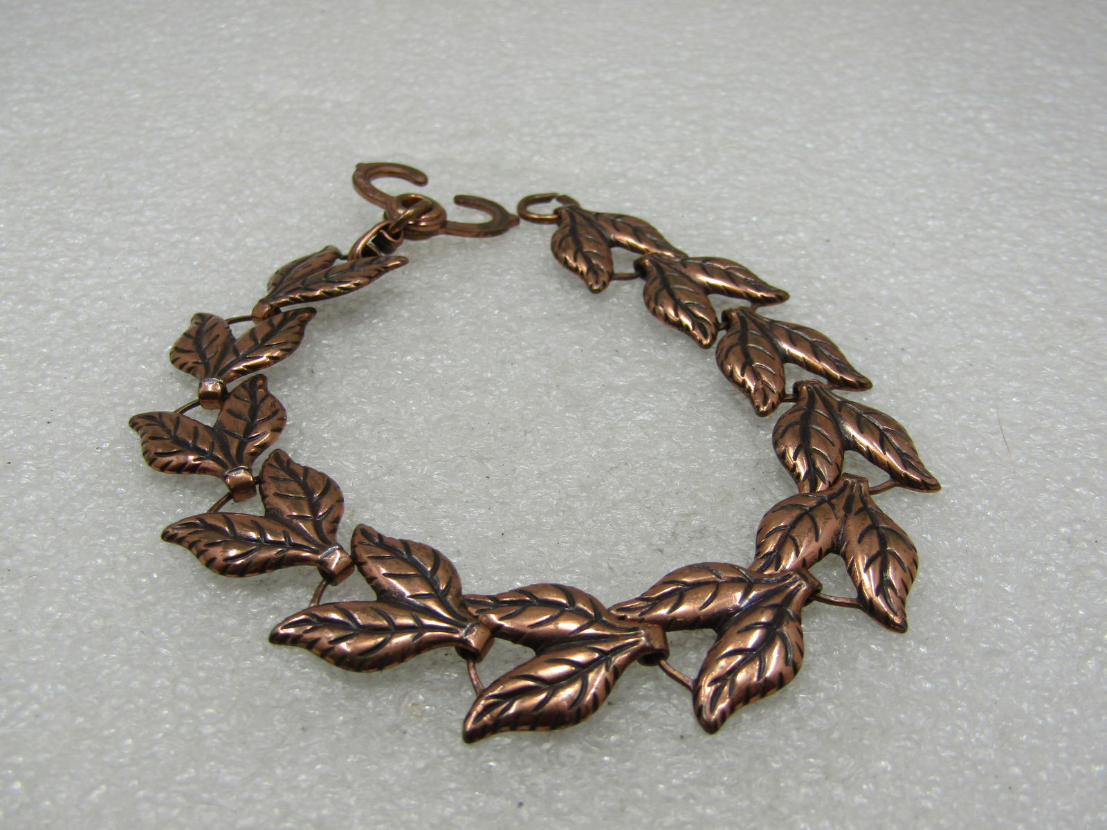 Vintage Copper Double Leaf Link Bracelet, 8": Vintage Copper Double Leaf Link Bracelet, 8", 5/8" wide. It has a sliding handcuff style clasp. It is marked copper on both sides of the clasp but not signed by the maker. The leaves have a stamped ve
