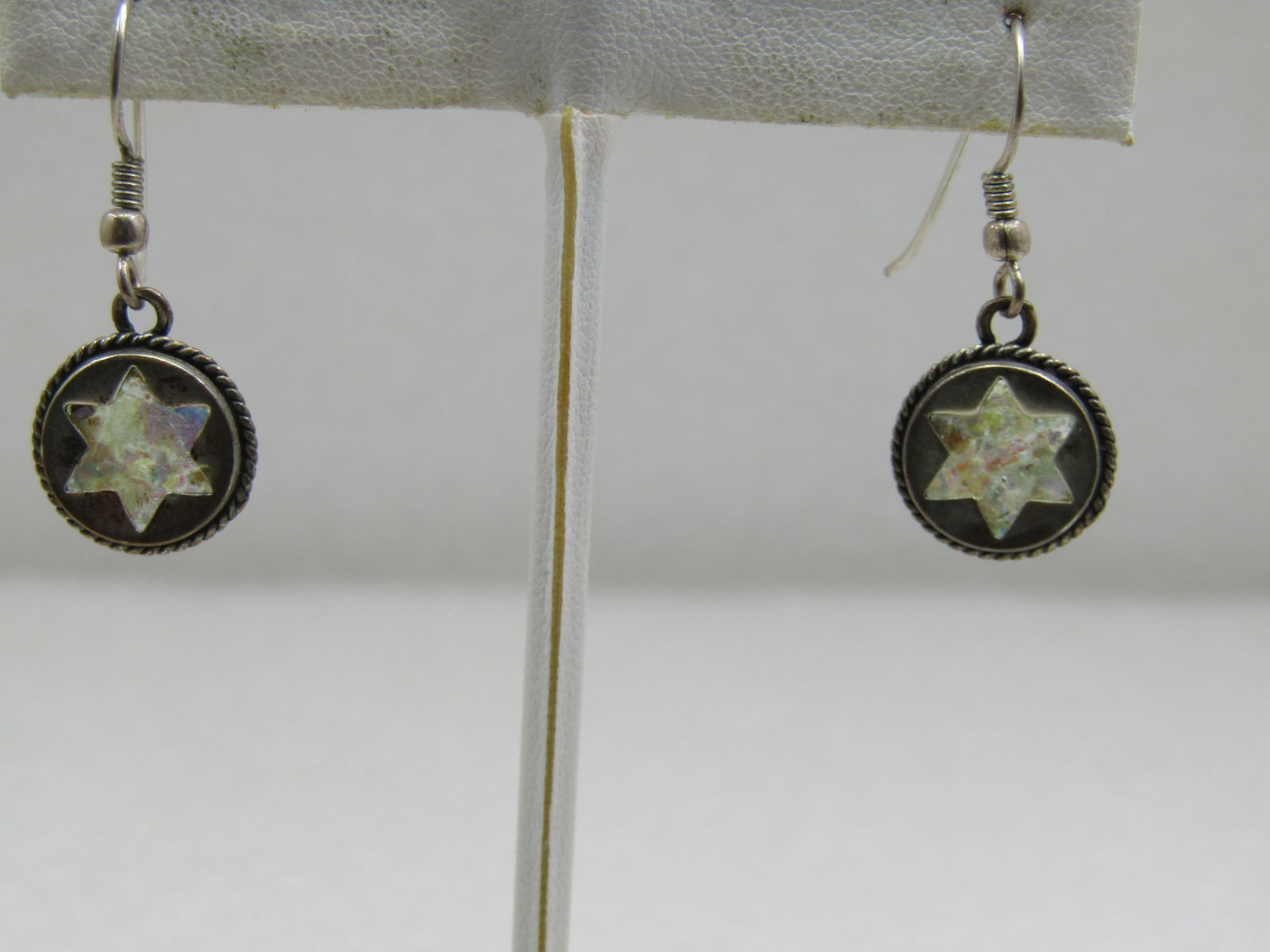 Vintage Sterling Glitter Star Earrings, Pierced, 1.25": Vintage Sterling Glitter Star Earrings, Pierced, 1.25" and appx. 3.10 grams. These are a circle with rope accent around the edge and a cut-out start that a glitter accent is visible through. The back