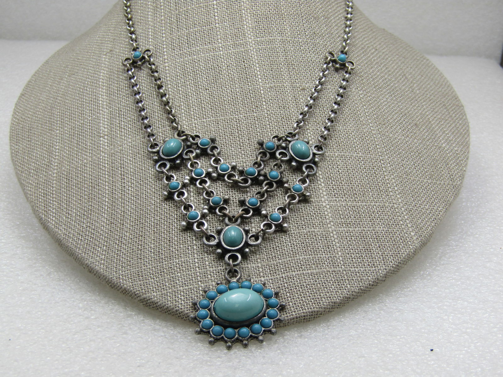 Vintage Southestern Faux Turquoise Bib Necklace, 15", Signed NR.: Vintage Southestern Faux Turquoise Bib Necklace, 15". Signed NR. Faux turquoise snake-eyes and oval stones in a bib/drop necklace that drapes at the front of the neck .nearly 3". Lobster clasp. Silver
