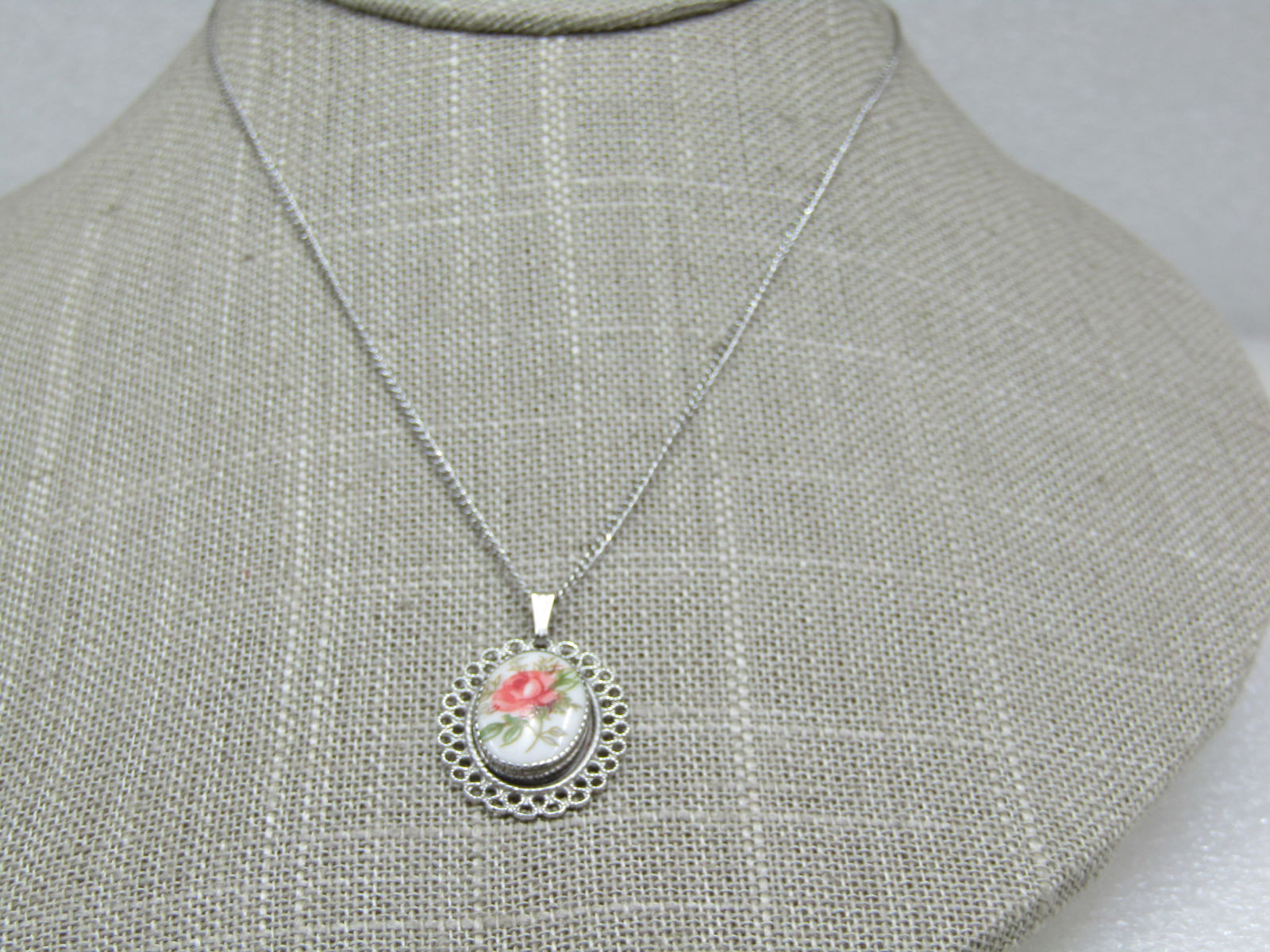 Vintage Beau Sterling Floral Necklace, 15", Filigree: Vintage Beau Sterling Floral Necklace, 15", Filigree framed, marked sterling and appx. 3.24 gr. The pendant has a pink rose with green leaves and is app, 1-1/8" long with bail. 3/4" wide. Chain is 15"