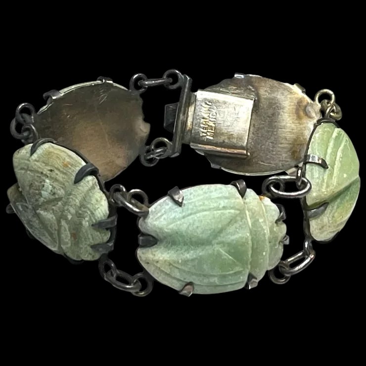 Vintage Oversized Carved Green Stone Scarab Bracelet: Title: Vintage Oversized Carved Green Stone Scarab Bracelet Description: Vintage Oversized Carved Green Stone Scarab BraceletHallmarked Sterling MexicoWeighs 46.1 gramsMeasures Approx. 6.5 inches leng