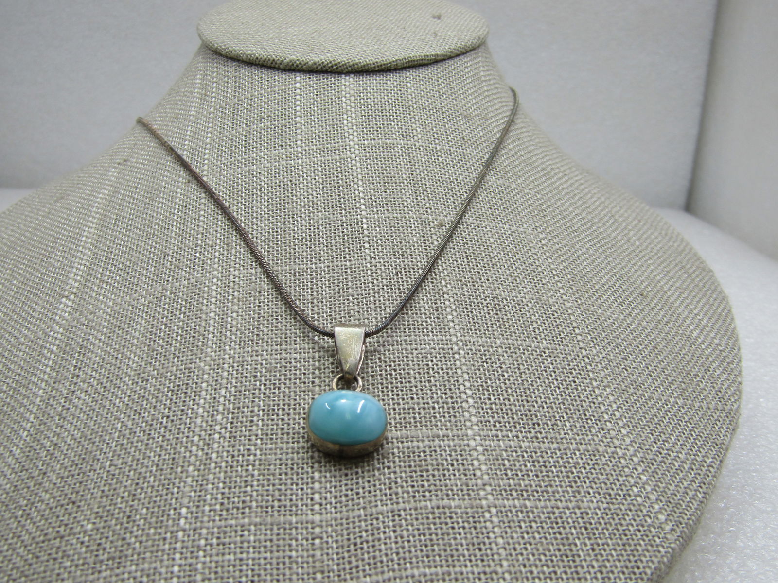 Vintage Sterling Larimar Necklace, 18", 1970's-1980's: Vintage Sterling Larimar Necklace, 18", 1970's-1980's. 18" 1mm round snake chain with a 7/8" pendant has a swing bail and oval 12mm by 10mm larimar stone bezel-set on it's side. That measurement inclu