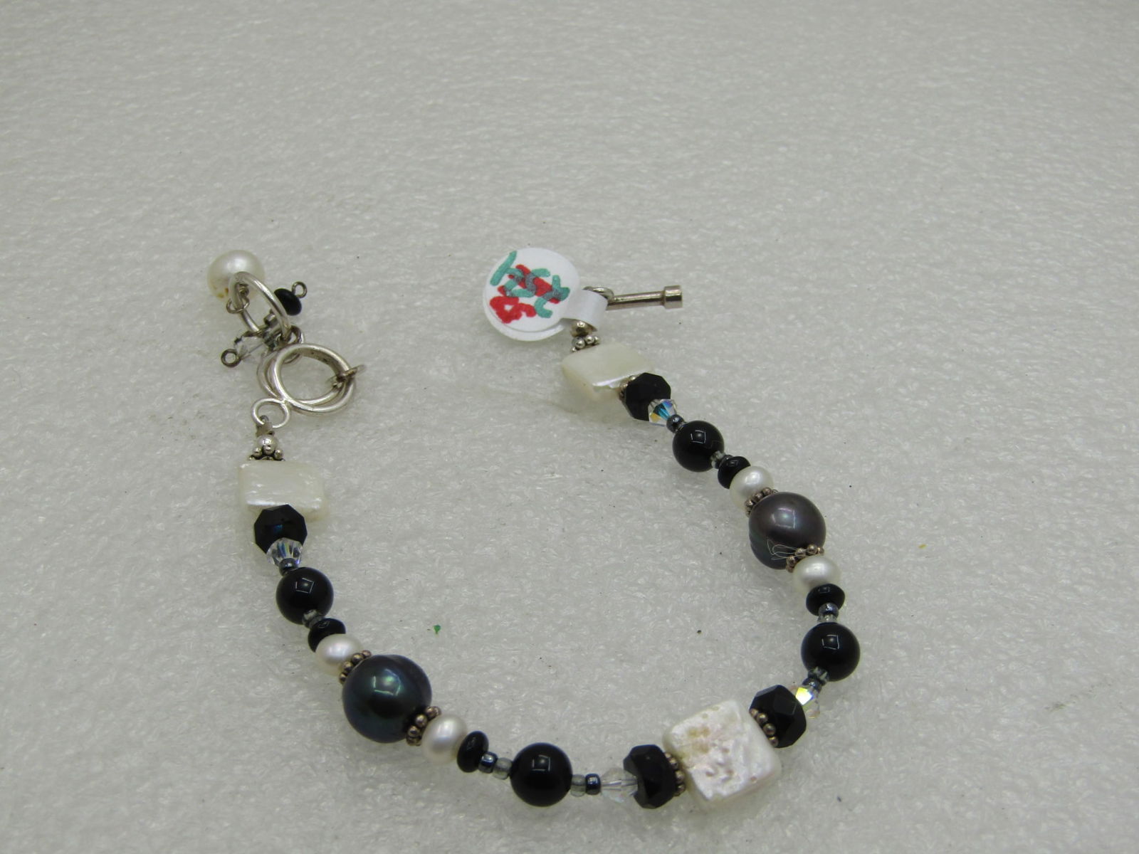 Sterling Silver Tahitian Pearl Bracelet with Freshwater Pearls, 8, Adjustable: Sterling Silver Tahitian Pearl Bracelet with freshwater pearls, 8" long with a few rings for the toggle to adjust shorter with a dangle if desired. Dark Tahitian baroque style pearls with black glass