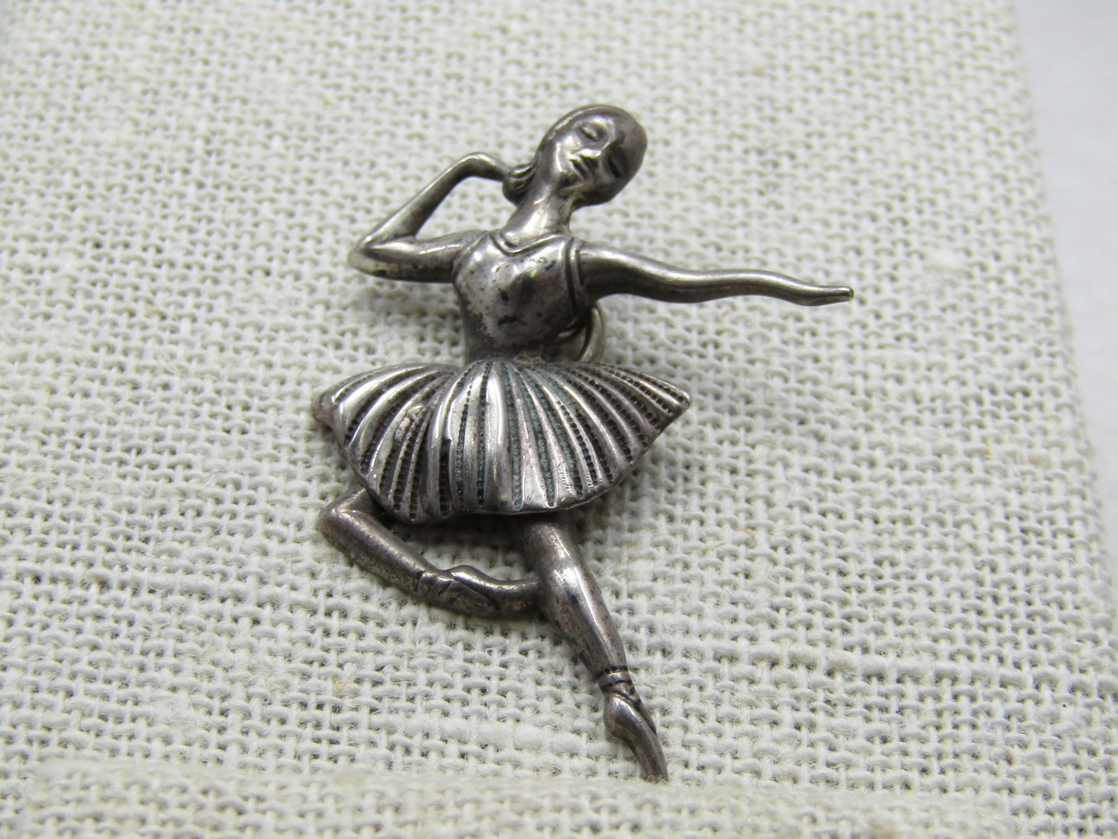 Vintage Sterling Ballerina Pendant, 1.5" Mid-Century: Vintage Sterling Ballerina Pendant, 1.5" Mid-Century, 2.42 gr. The ballerina is a dancing pose with one arm bent and one extended. Ridged/fluted skirt. Marked sterling and tested. Very good condition